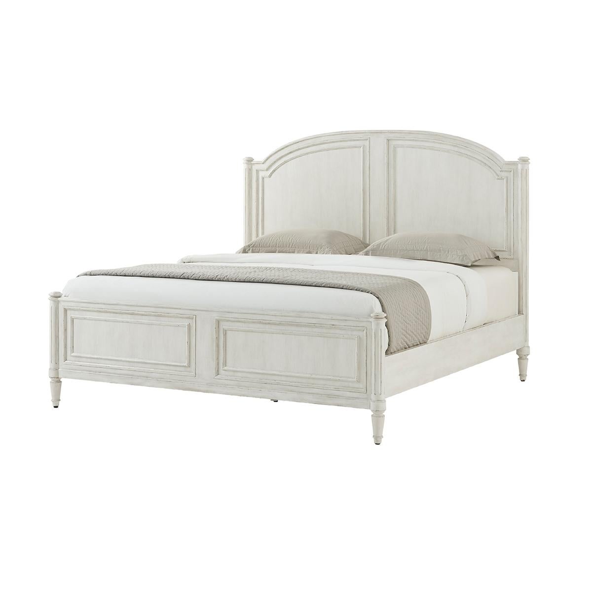 A white washed painted four post king size bed with carved arch panel headboard and paneled footboard with turned posts having ball finials and raised on fluted styles and turned and tapered feet.

Dimensions: 77.5