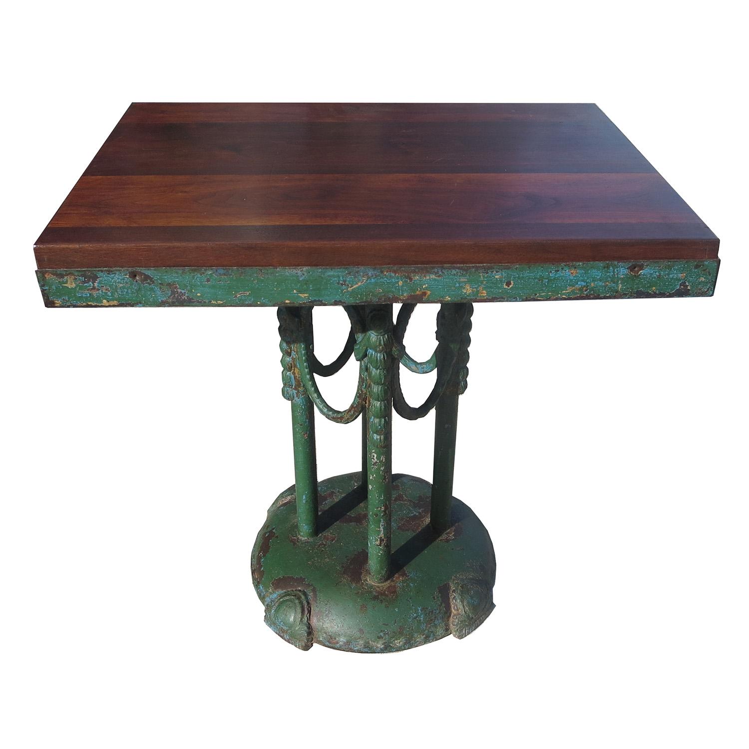 This table has an incredible patina of age, displaying thick and chipped paint. The base is a cast iron, with great decorative elements. The top is solid walnut, with a more recent finish. Needless to say, the table is solid and heavy! It's a