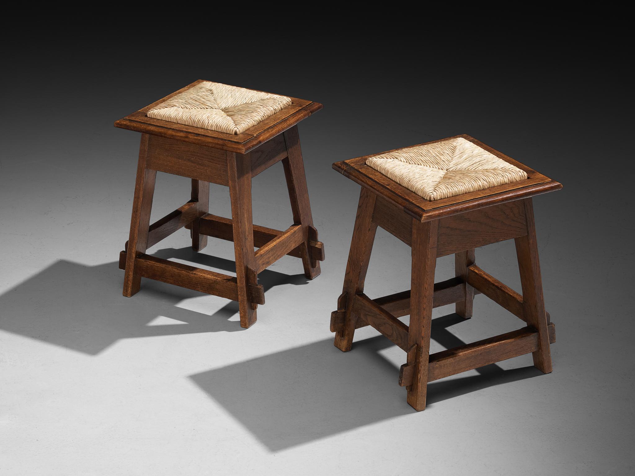 Pair of stools, rush, oak, the Netherlands, 1940s

Rustic pair of 1940s Dutch stools. The legs extend downward in a straightforward, slightly tapering silhouette. The rush seats offer a warm, organic contrast to the hard-edged oak frames. The edges