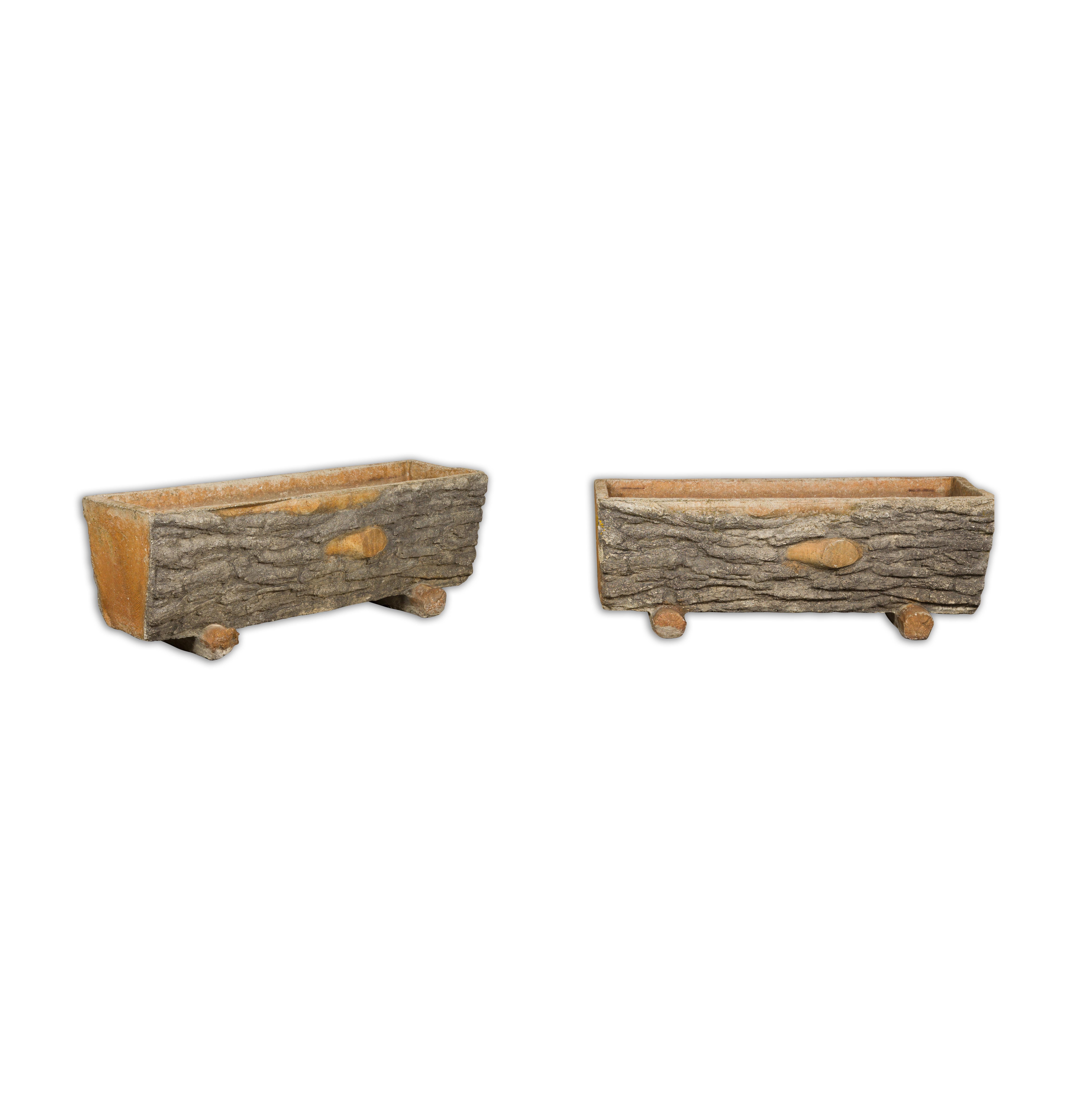 A pair of faux-bois trough shaped planters from the Midcentury period, made of concrete and accented with grey and orange tones. Breathe an air of rustic charm into your garden with this pair of Midcentury faux-bois trough-shaped planters. Each