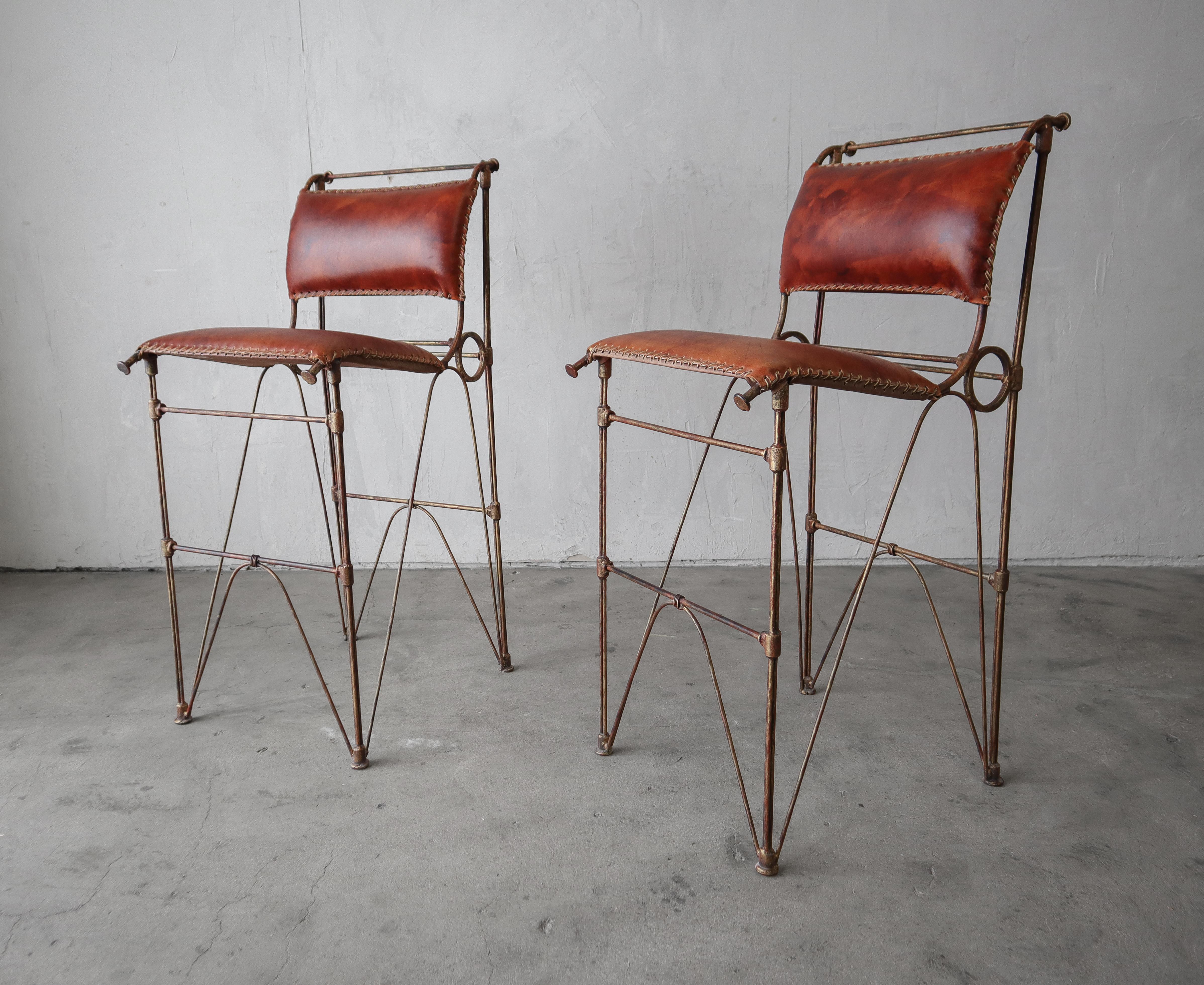 Nice rustic pair of leather bar stools after Ilana Goor.  The hand stitched leather and metal details on these stools make them so unique and beautiful.

Stools are installation ready.  They are in excellent condition with no damage to be noted.