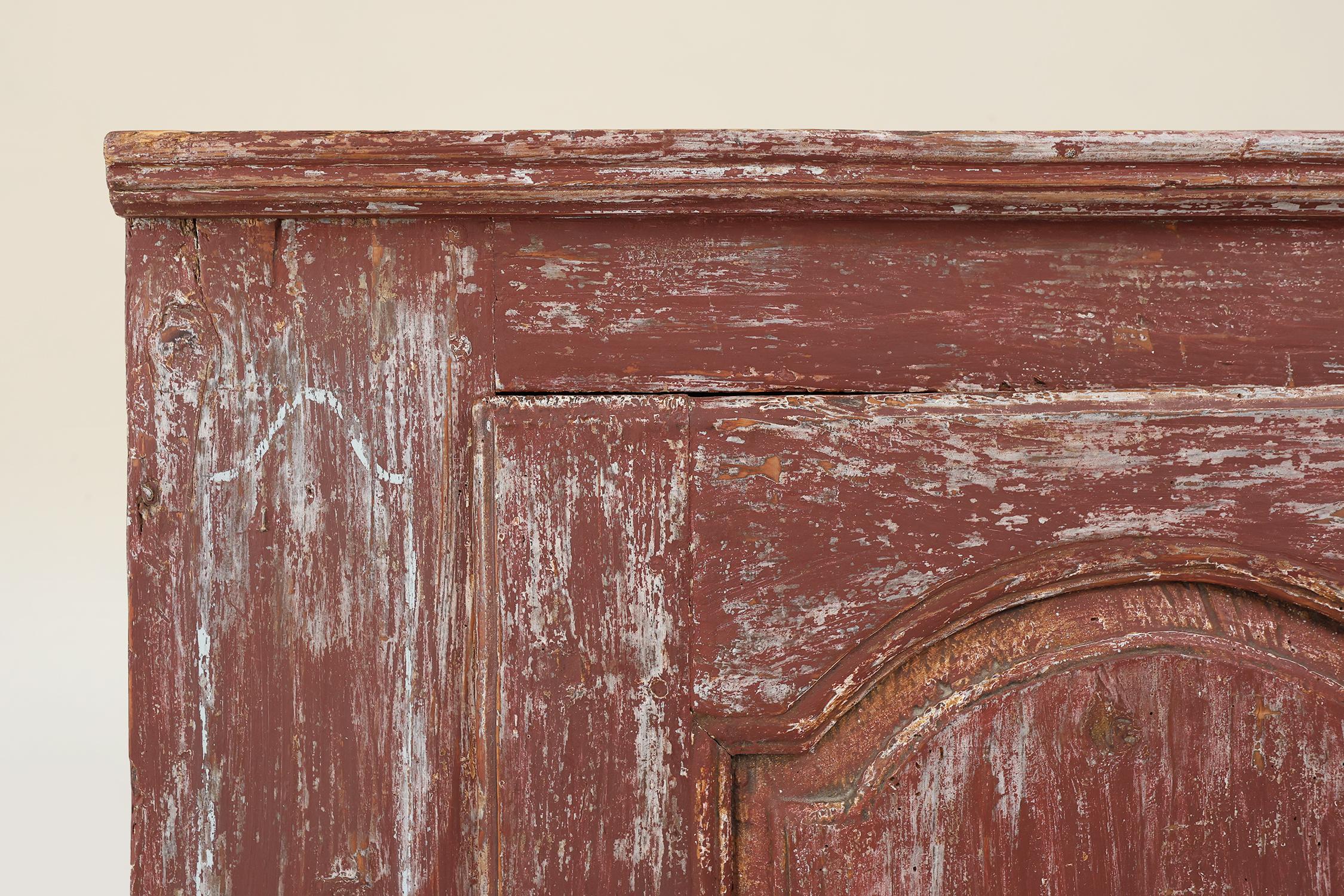 French Rustic Parisian cabinet in pine wood with old burgundy paint layers, ca. 1820 For Sale
