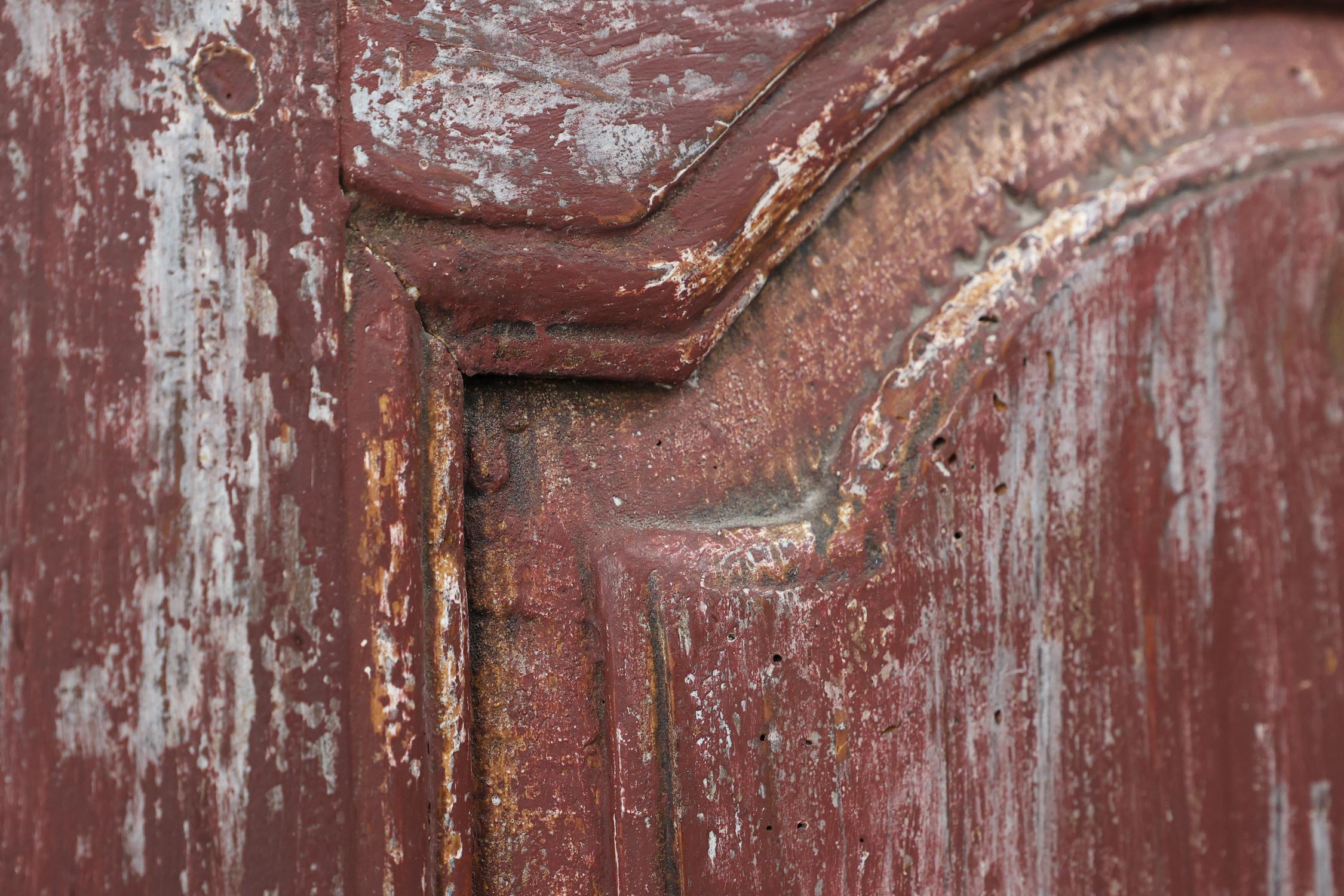 Hand-Carved Rustic Parisian cabinet in pine wood with old burgundy paint layers, ca. 1820 For Sale