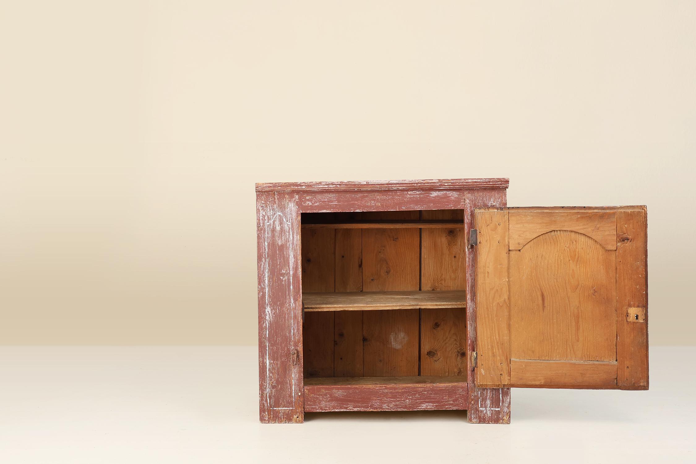 Rustic Parisian cabinet in pine wood with old burgundy paint layers, ca. 1820 For Sale 1