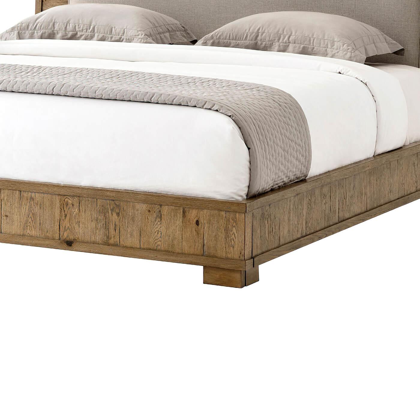 European Rustic Oak and Oak parquetry king size bed finish in a light echo oak finish, with planked parquetry framed headboard and rails, an upholstered panel headboard insert on a recessed platform base.

Dimensions: 81