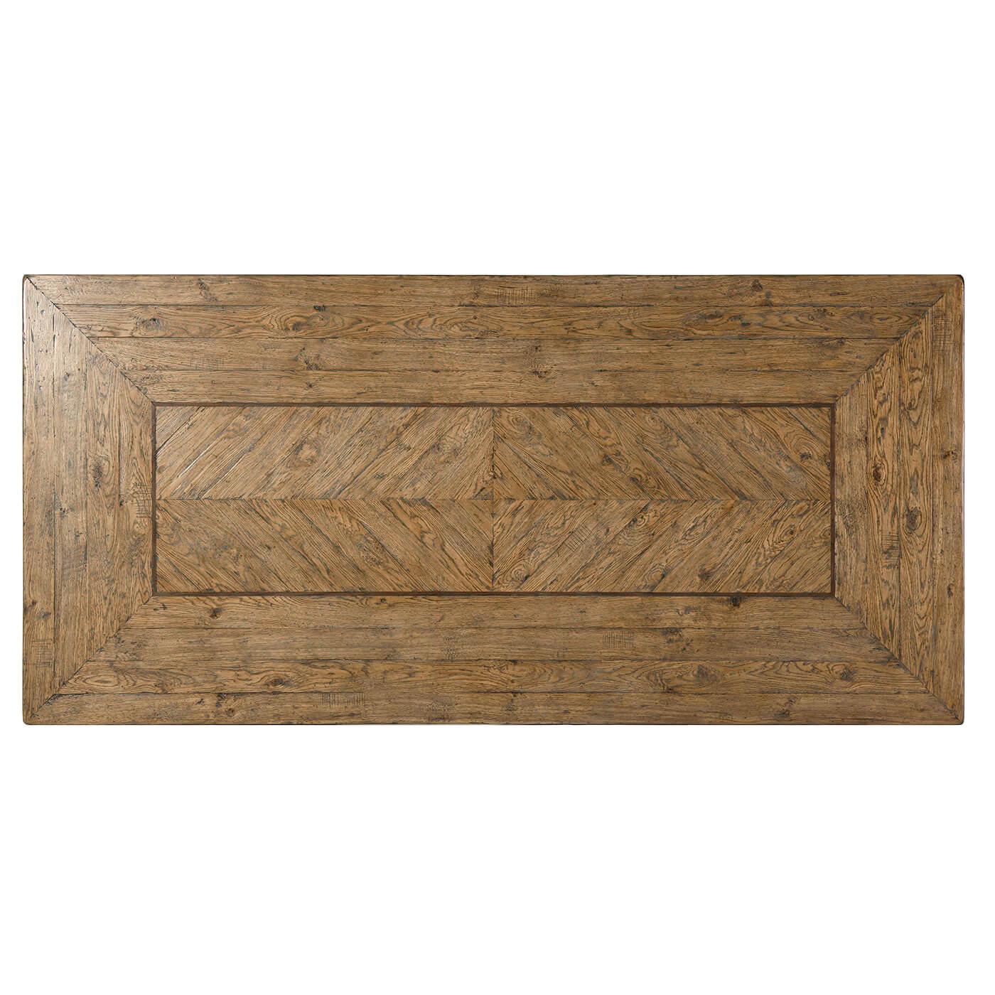 Rustic parquetry oak dining table with chevron panel details with a walnut line inlay and a vintage textured metal geometric trestle end base.

Dimensions: 88