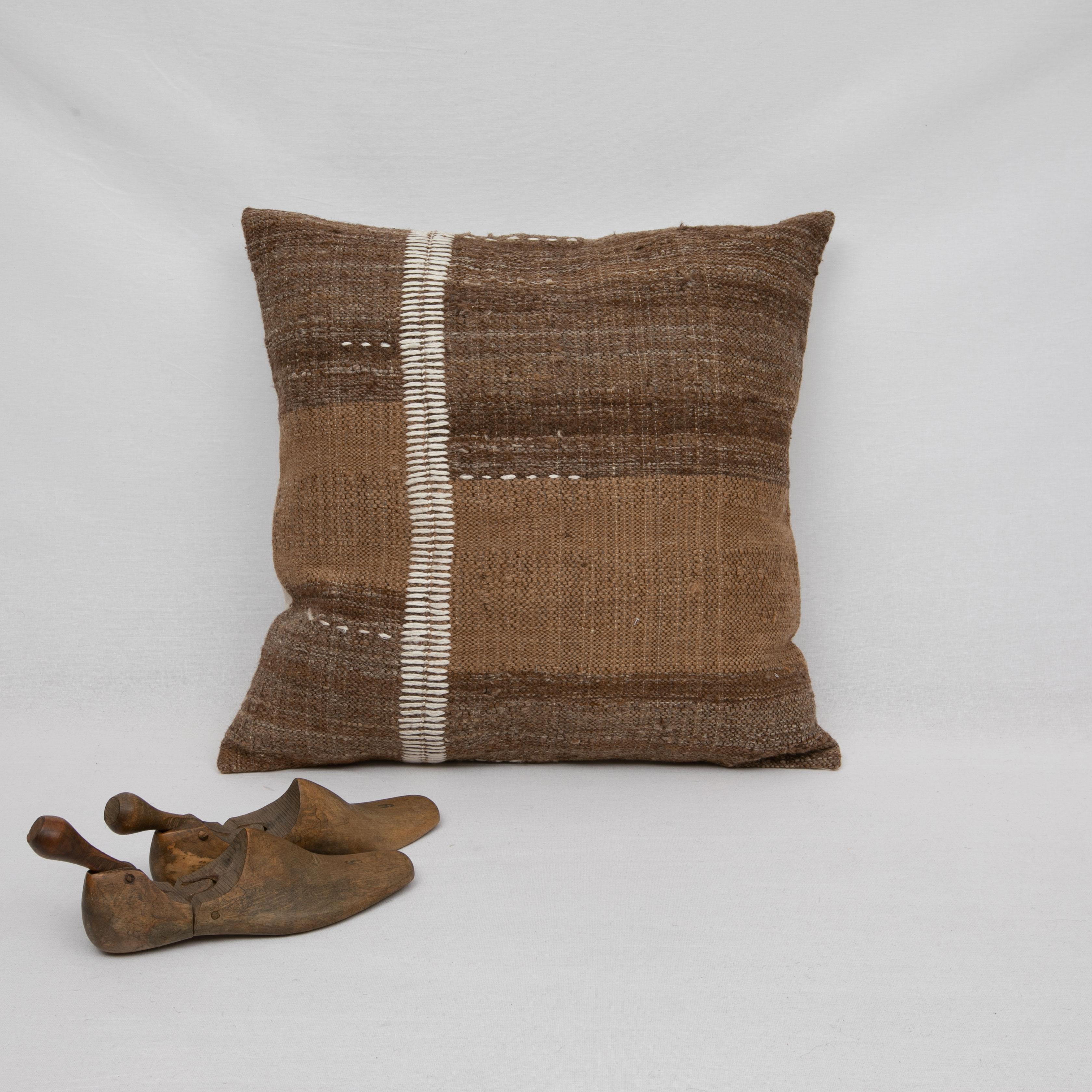 This pillow is made from a vintage coverlet that is hand woven using un-dyed wool.
Our addition to the piece is silk hand stitching.

It does not come with an insert.
Linen in the back.
Zipper closure.
 