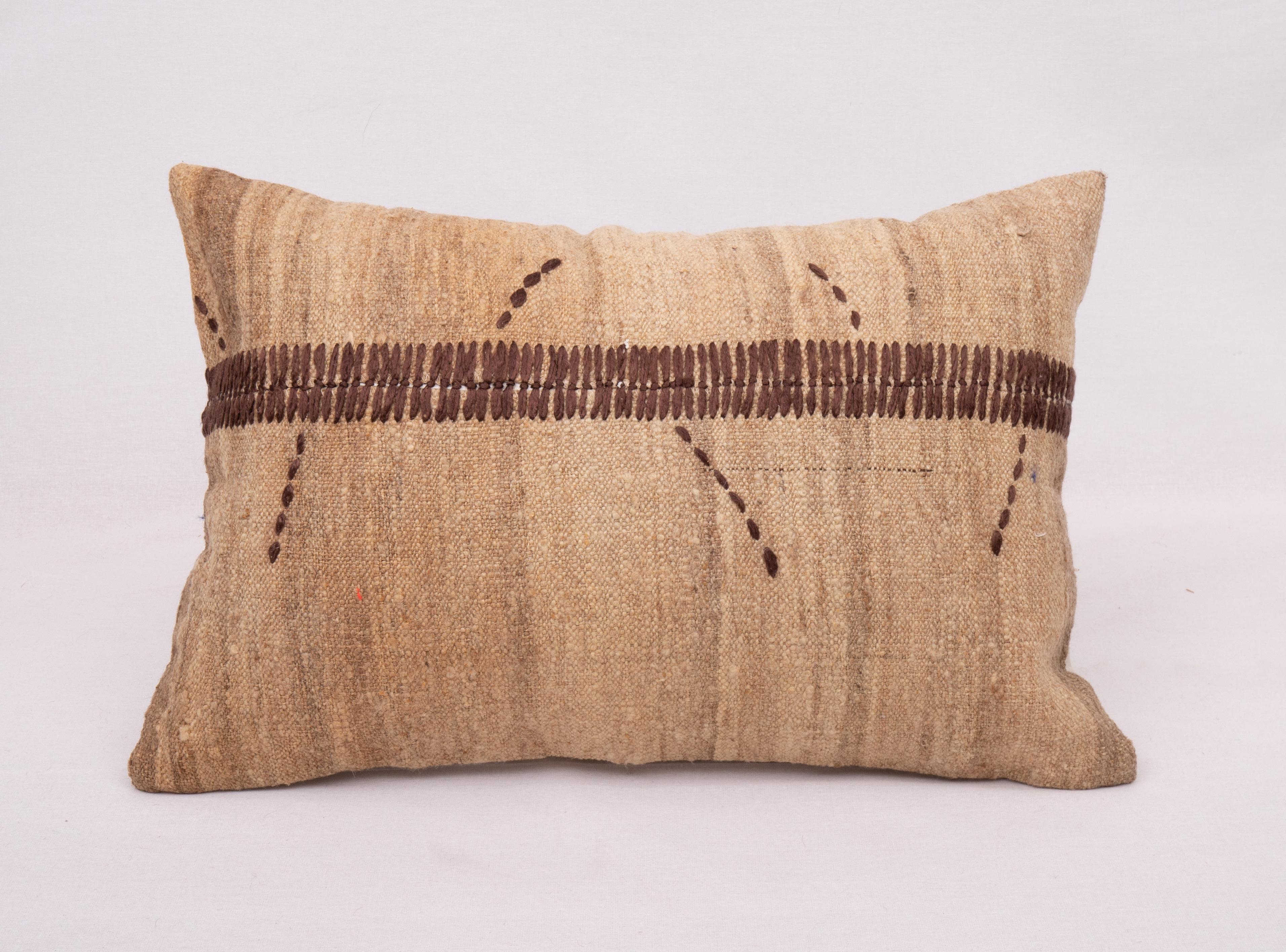 This pillow is made from a vintage coverlet that is hand woven using un-dyed wool. Our addition to the piece is silk hand stitching. It does not come with an insert. Linen in the back. Zipper closure