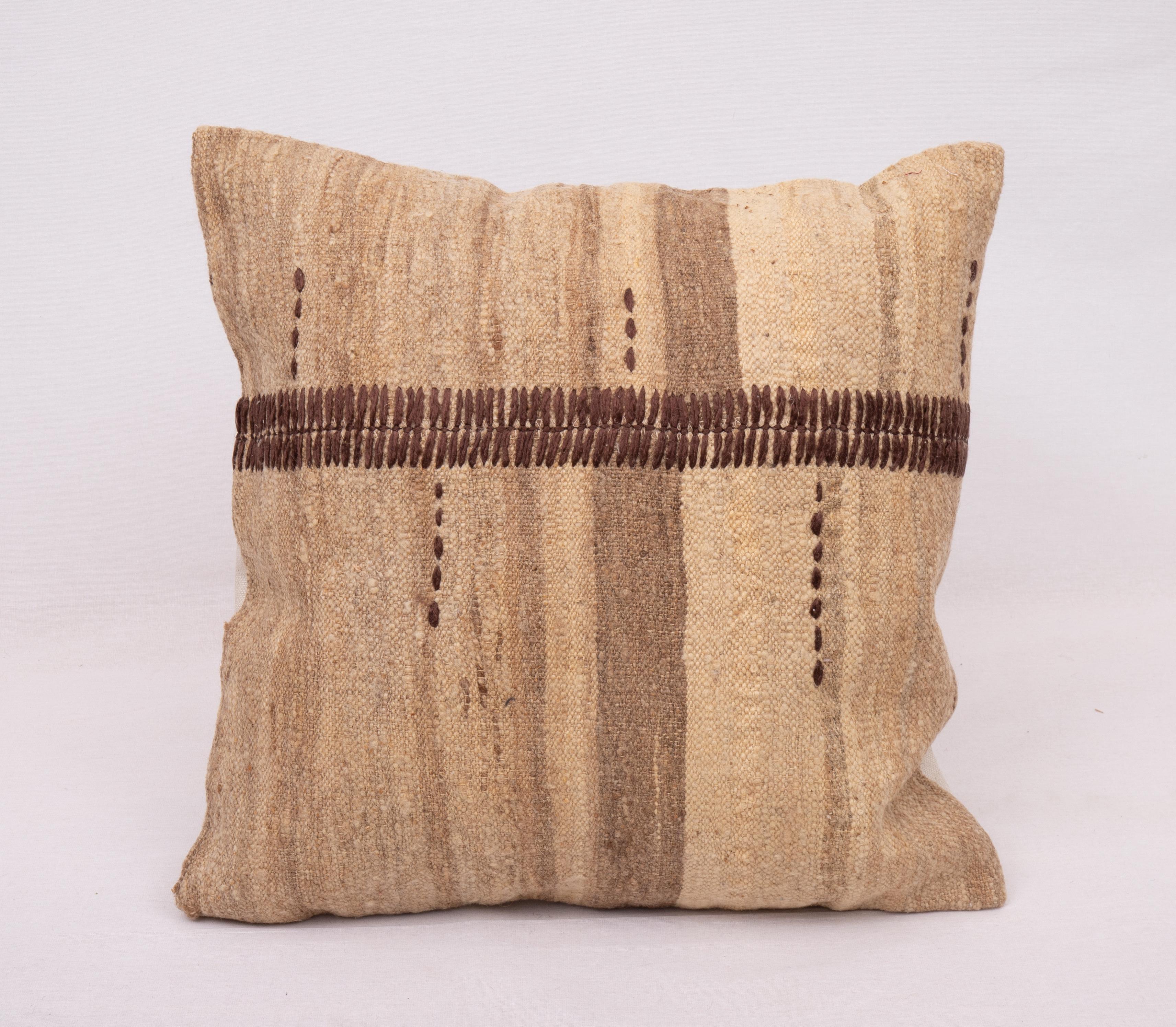 This pillow is made from a vintage coverlet that is hand woven using un-dyed wool. Our addition to the piece is silk hand stitching. It does not come with an insert. Linen in the back. Zipper closure.