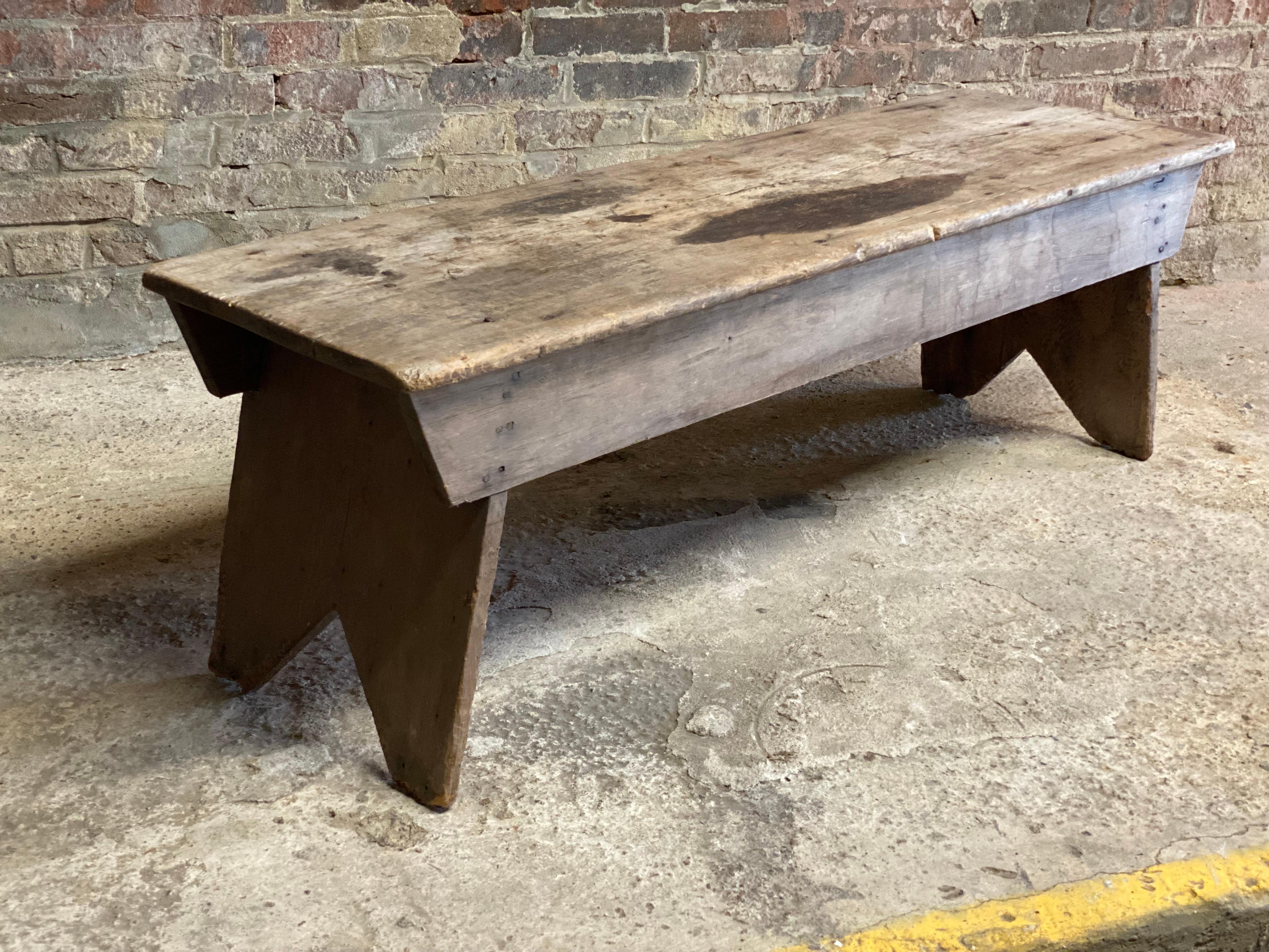 Simple and classic rustic five board Adirondack bench. Beautifully weathered and worn patina. Nice single old growth pine panel seat. Splayed cutout legs. Circa 1920-30. The much needed farmhouse hall bench. Multiple uses as a console, coffee table,