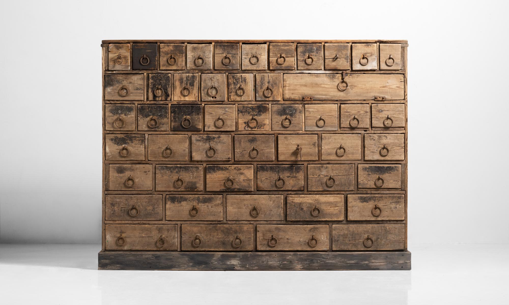 Rustic bank of drawers, England, circa 1870.

Primitive chest with iron ring pulls.