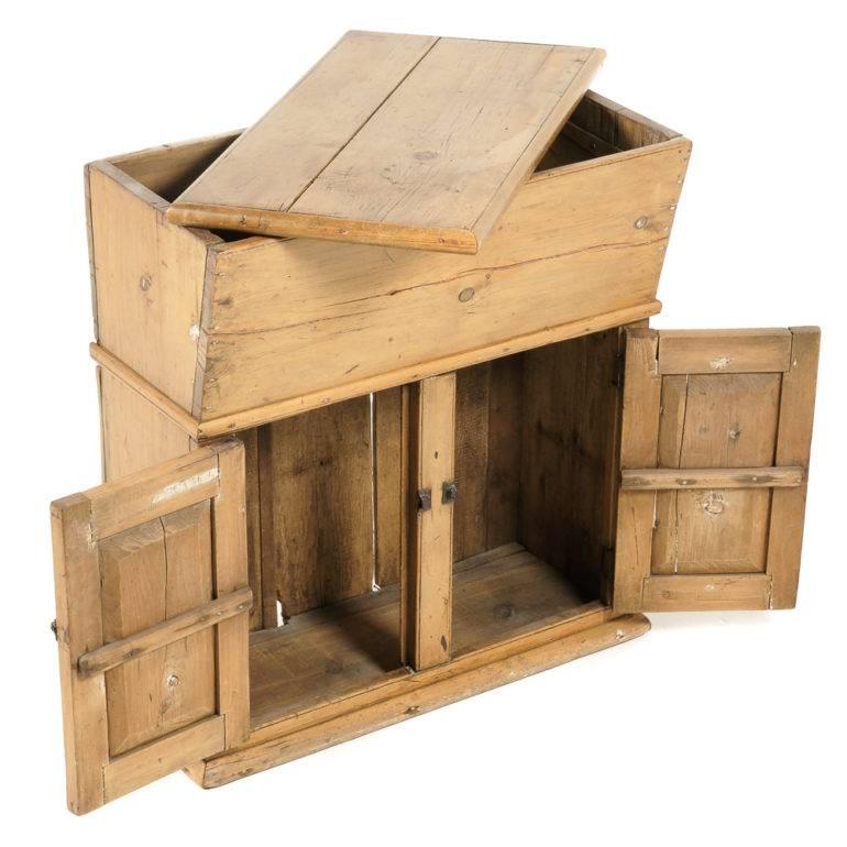 A pine Canadiana cabinet with two latched doors below a lidded upper bin (dough bin?), possibly for bread making, circa 1890.


 