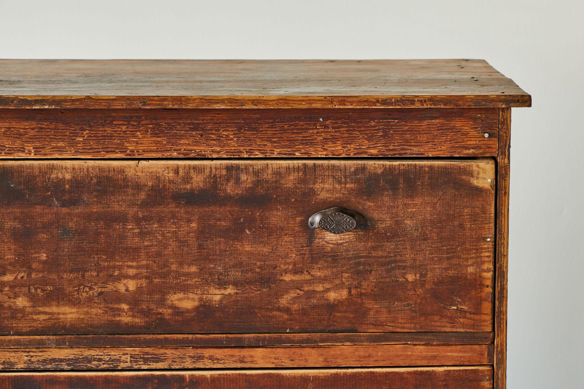 Rustic pine three-drawer chest of drawers with original pull hardware and original finish.