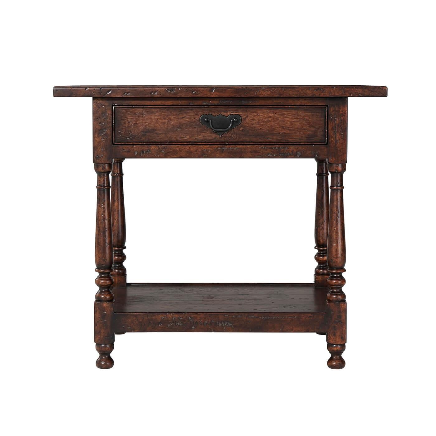 A William and Mary style reclaimed oak veneered and mahogany accent table, the planked top with a raised edge, above a frieze drawer and baluster turned legs joined by an under tier, on bun feet.

Dimensions: 30