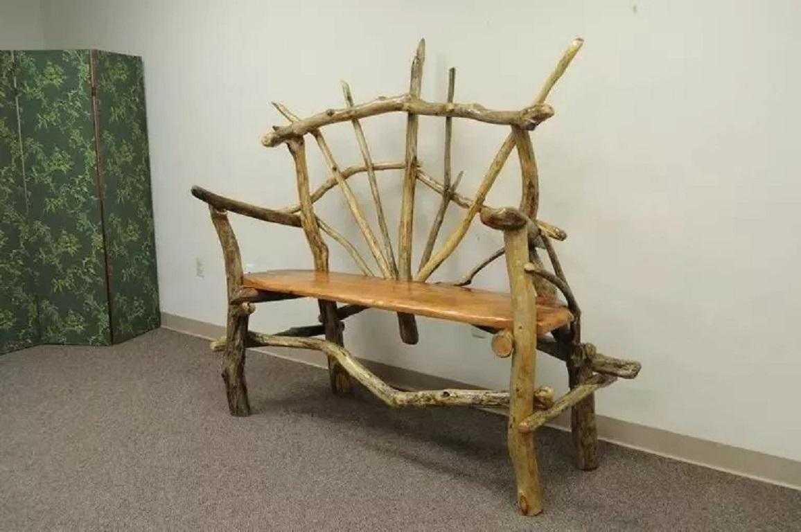 Rustic Primitive Artisan Tree Log Driftwood Garden Patio Bench by Robert Powchik. Item featured was locally sourced and crafted from real tree logs in New York by artist Robert Powchik. Circa 21st Century. Measurements: 66