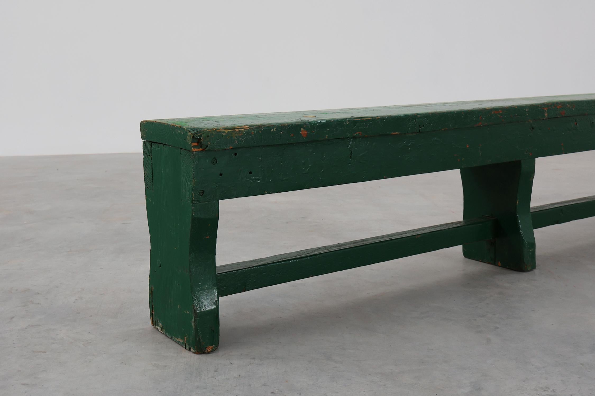 France / 1900 / bench / oak / Rustic

French Antique large green painted bench with beautiful patina and nice old layers of paint that give it its rustic charm. This bench in solid oak is crafted to a simplified, primitive silhouette. The bench