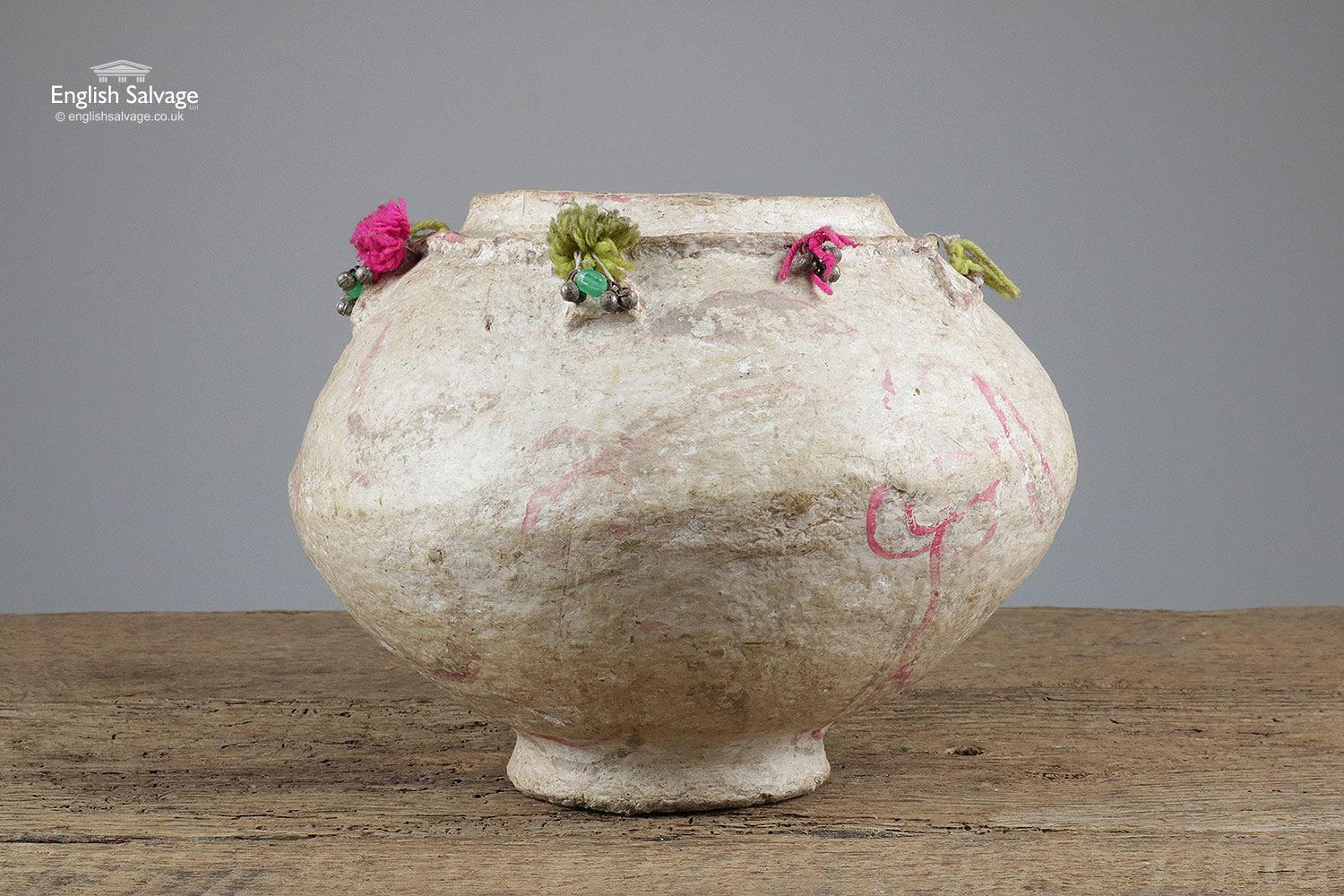 Unusual reclaimed cream or beige papier mâché pot with pink highlights and pink and green beading and yard decoration around the rim. The pot has a rustic appearance.