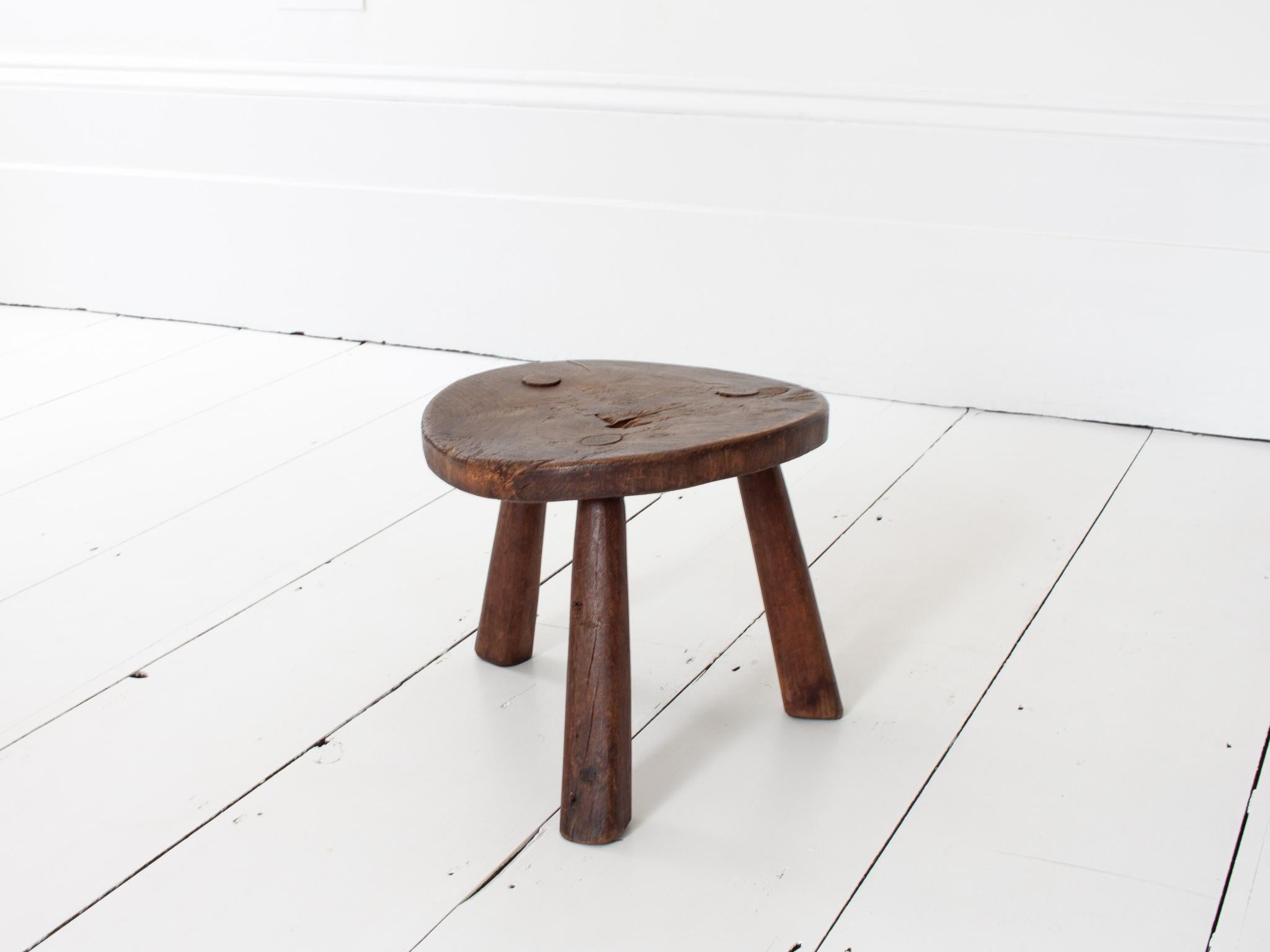 Rustic, Primitive, Wabi Sabi, Antique, Naive Vintage Stool/Table, England, c19th Century.

A rustic stool which would also serve as a side/coffee table.  Sitting on three splayed tapered legs and formed of oak with a great gnarly aesthetic. 