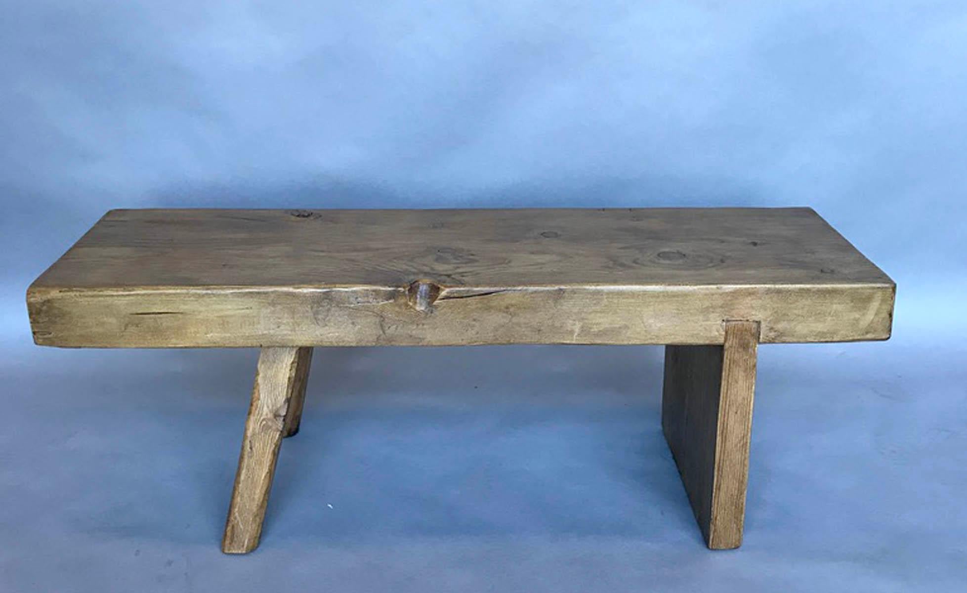 Fun little bench with one perpendicular base and two hand chiseled legs. The top is about 3