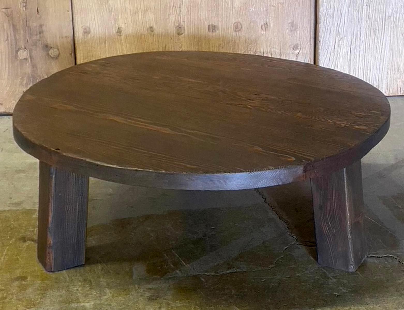 Round rustic coffee table with three legs made in reclaimed Douglas fir. Reclaimed wood may show surface cracks, nail holes and knots. Finish is smooth. Can be custom made in different sizes and finishes.