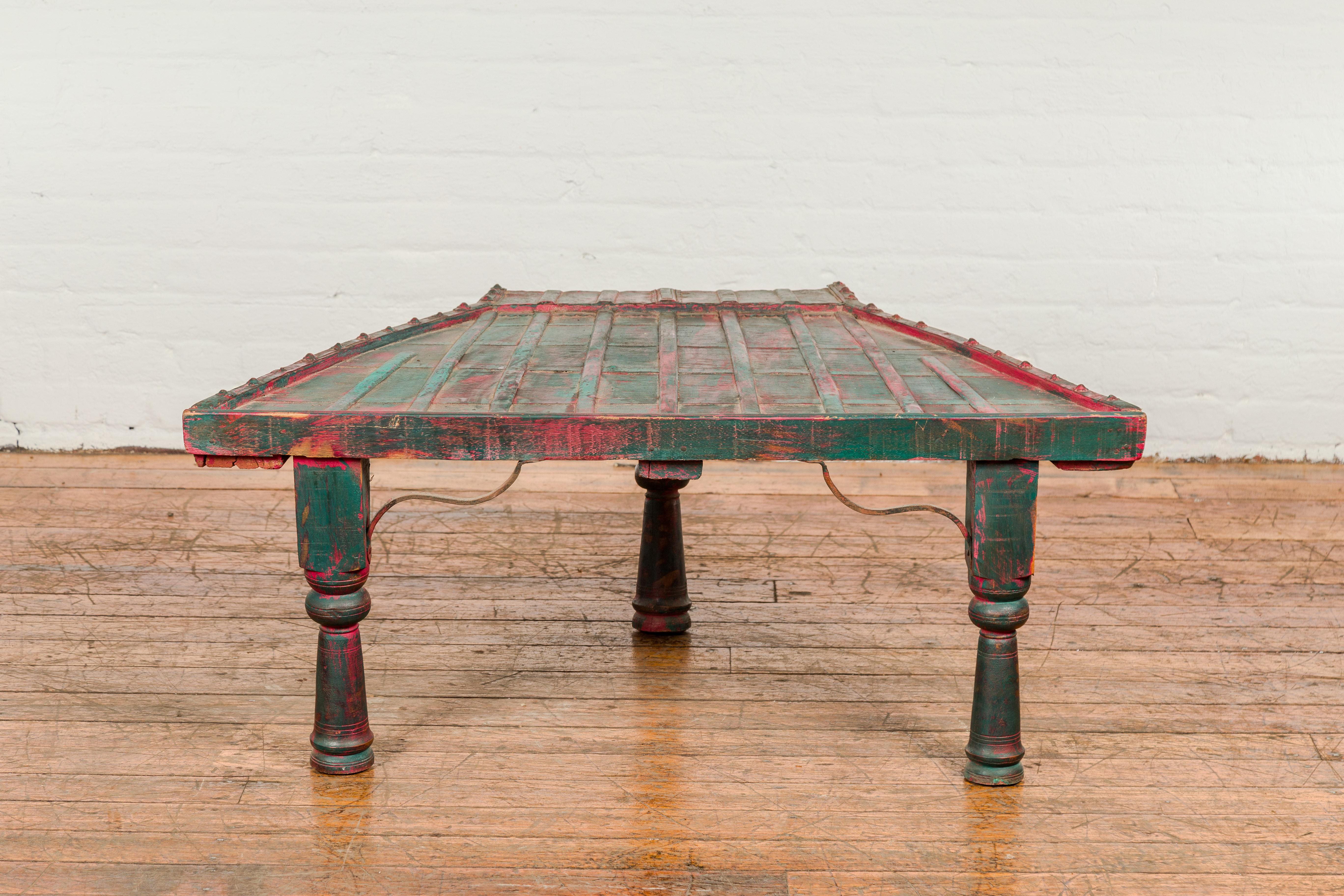 Indian Rustic Red and Green Coffee Table with Trapezoidal Top and Iron Stretchers For Sale