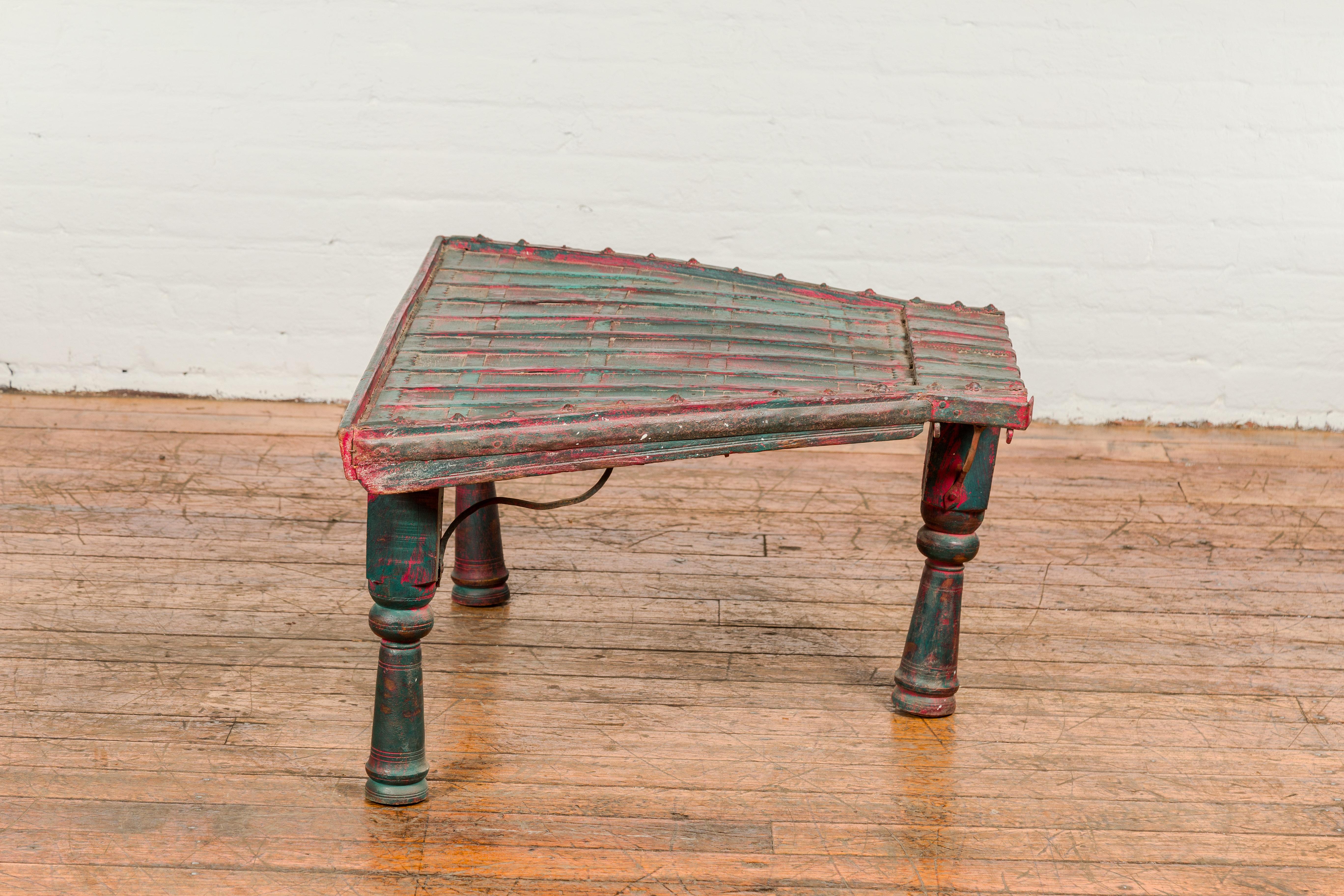 Painted Rustic Red and Green Coffee Table with Trapezoidal Top and Iron Stretchers For Sale