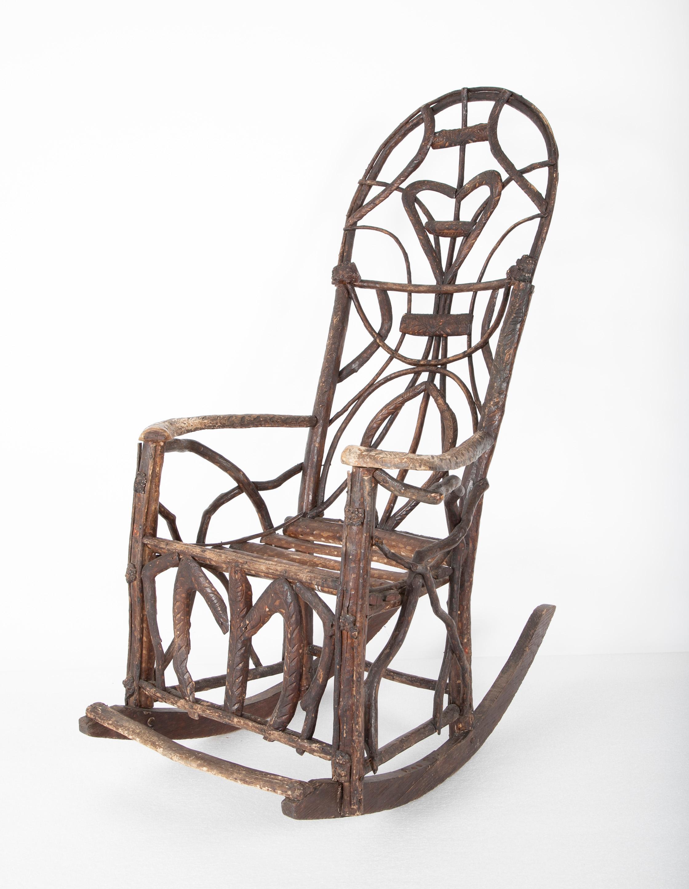 Rustic rocking chair attributed to Rev. Ben Davis of Blowing Rock, North Carolina. Chip carved decor & incised leaf & floral heart motif back, early 20th century.