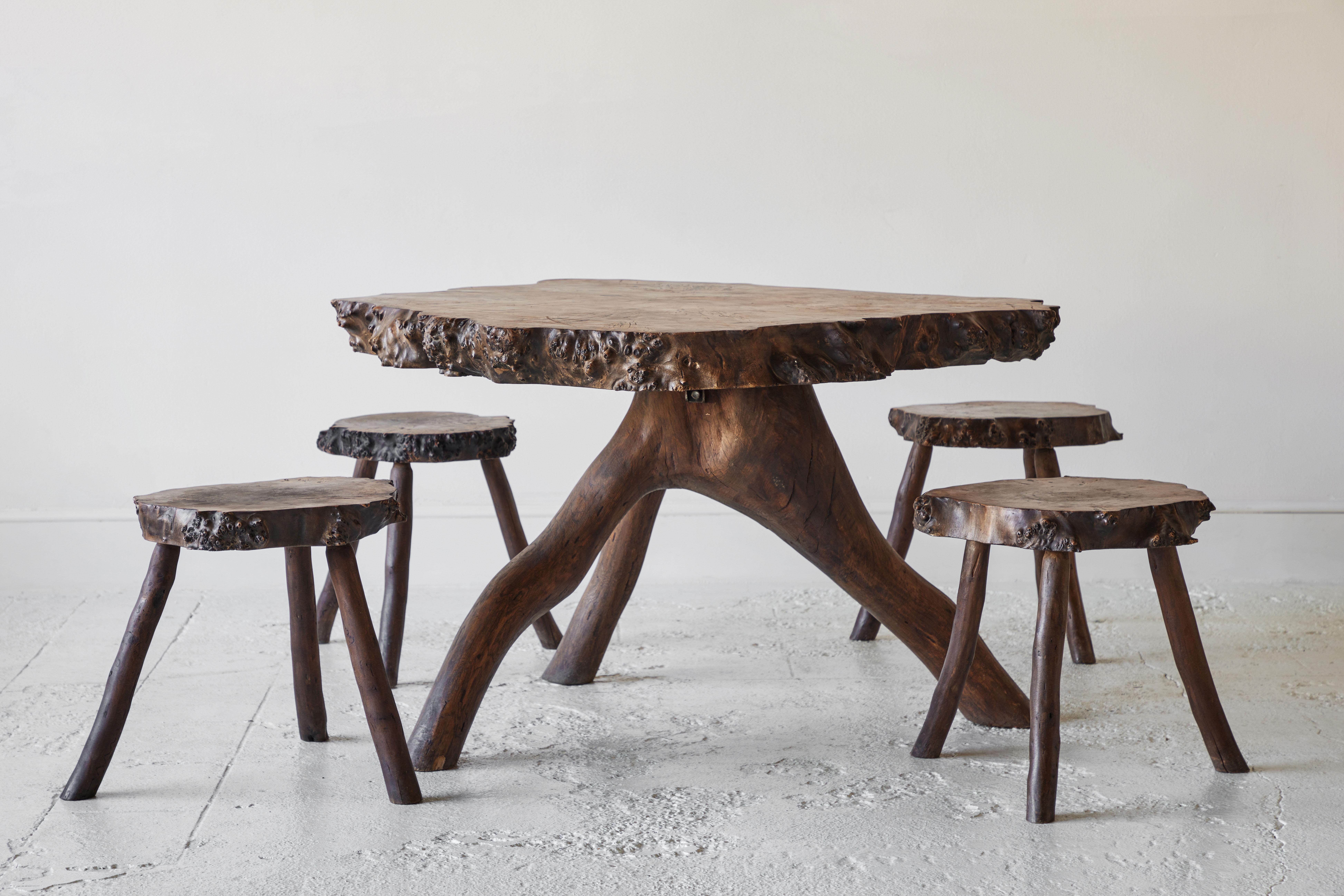 Beautiful rustic root table with a live edge top. The table comes with four matching stools.