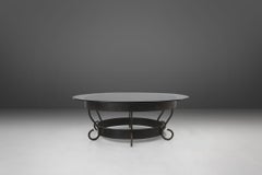 Rustic round coffee table with wrought iron base and glass top, France, 1930s