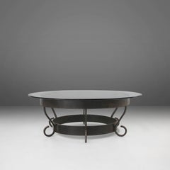 Rustic round coffee table with wrought iron base and glass top, France, 1930s