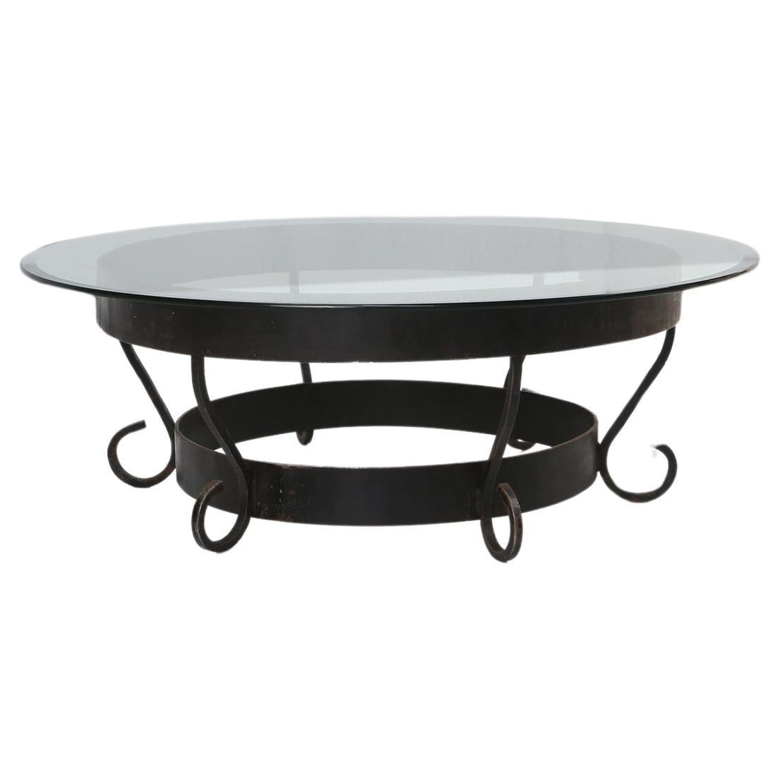 Rustic round coffee table with wrought iron base and glass top, France, 1930s For Sale