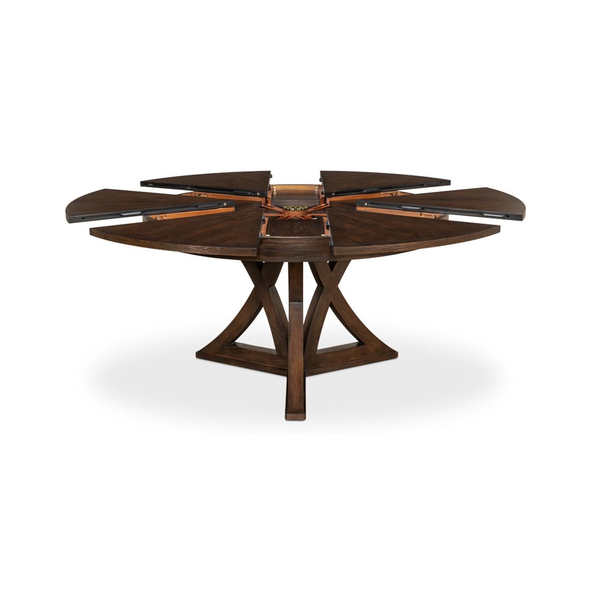 A Transitional Rustic oak round Jupe extending dining table in our burnt brown finish. The oak table in our warm finish is a great combination of classic style and modern amenities. Closed it is 54