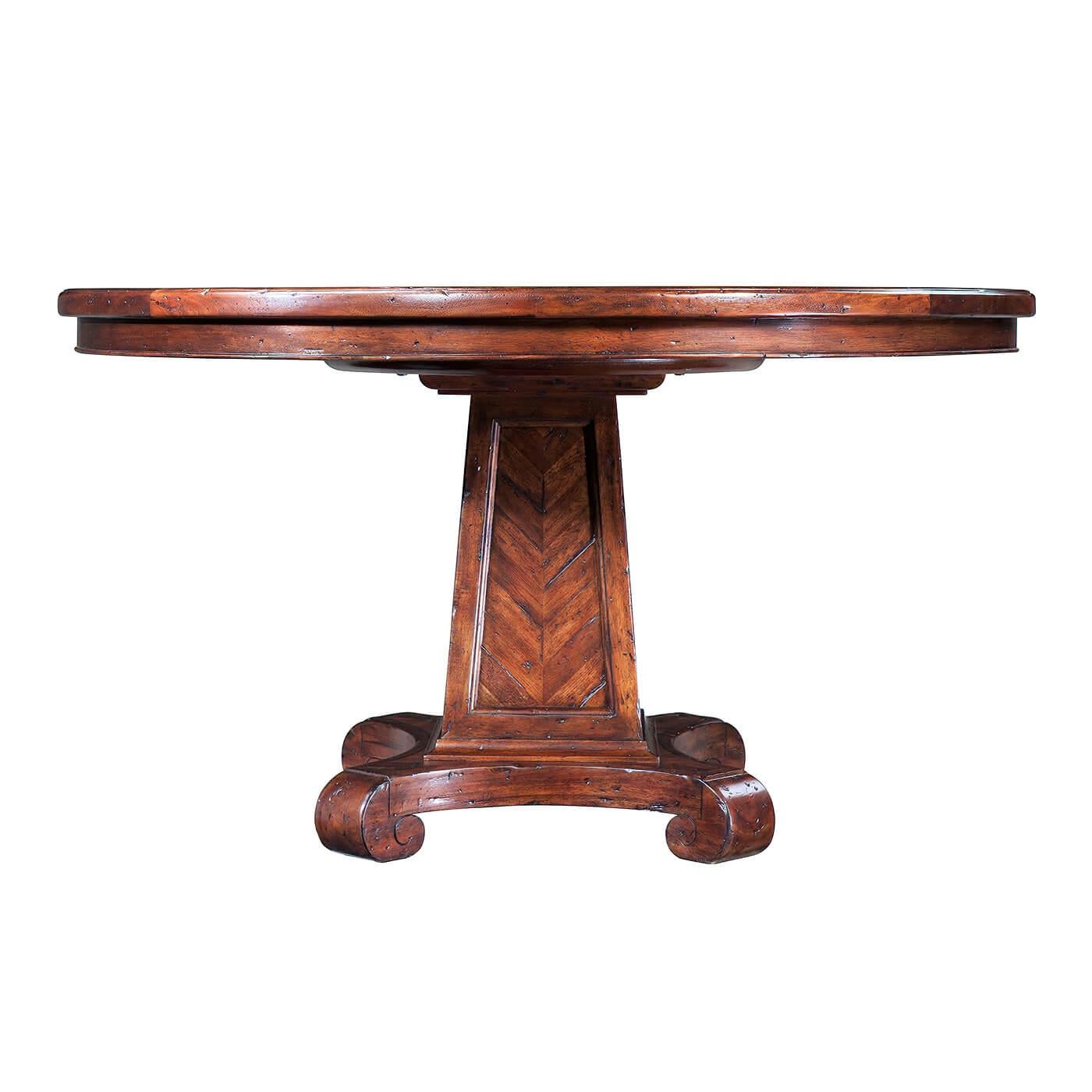 An antiqued wood dining table, the planked circular molded edge top with a stellar parquetry medallion above a chevron parquetry tapering column, on a quatrefoil base with under scroll feet. Inspired by a Regency original.

Dimensions: 54