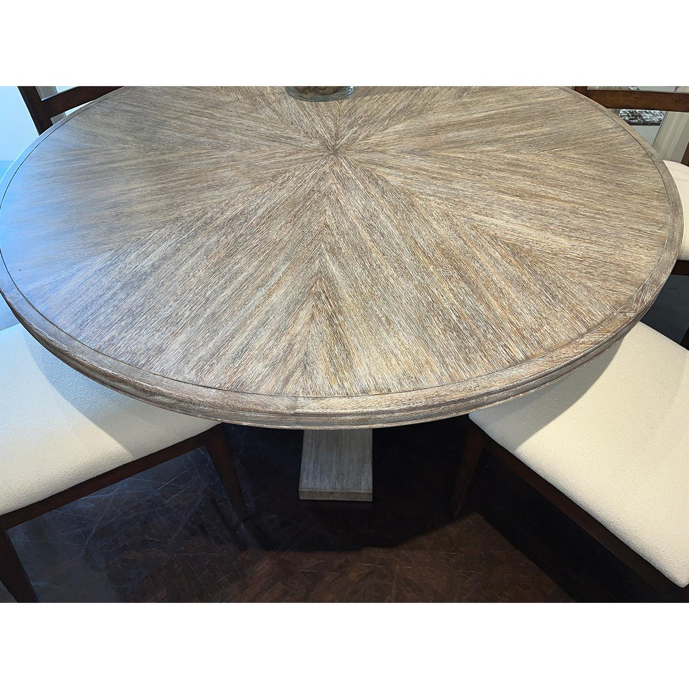 The round top showcases a stunning radial pattern, creating a captivating focal point for your dining area.

Crafted from solid and veneered acacia wood, this table promises durability and longevity, making it a perfect centerpiece for family