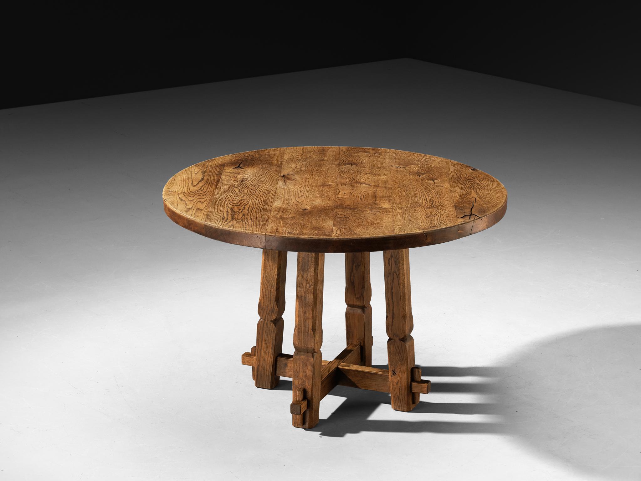 Dining or center table, solid oak, 1960s, Europe

Provincial hand-carved table, embodying the perfect balance of rustic charm and a sense of robustness. Its thick circular tabletop in oak reveals the organic grain of the wood, emphasizing the
