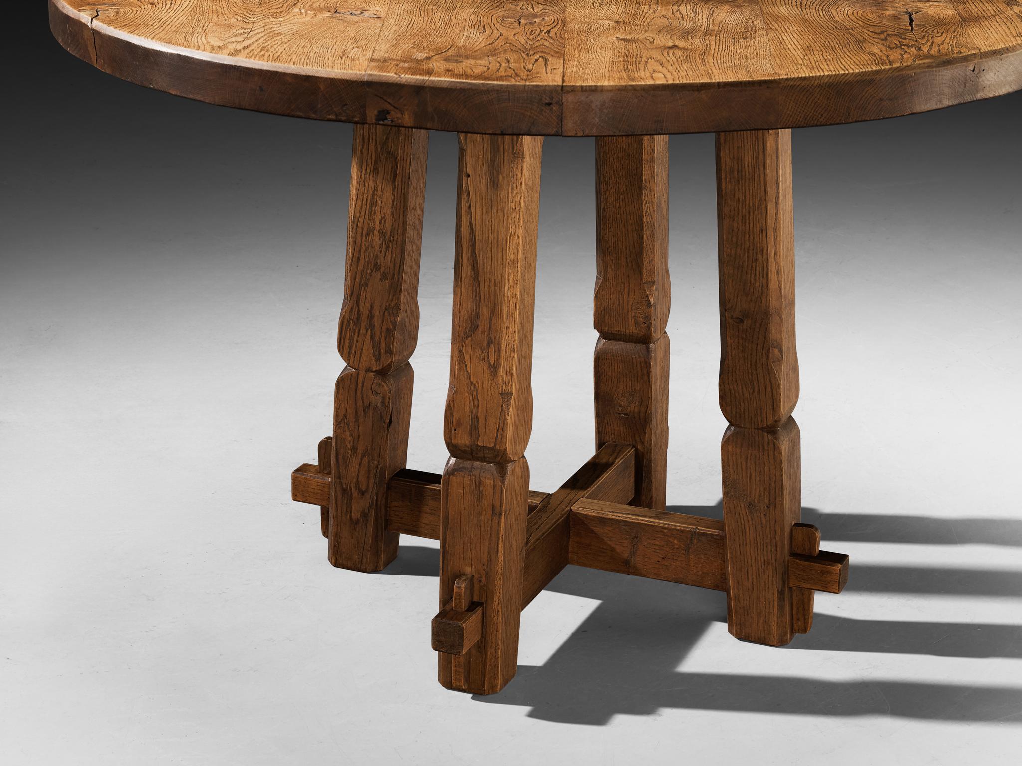 Mid-20th Century Rustic Round Dining Table in Solid Oak with Carved Base For Sale