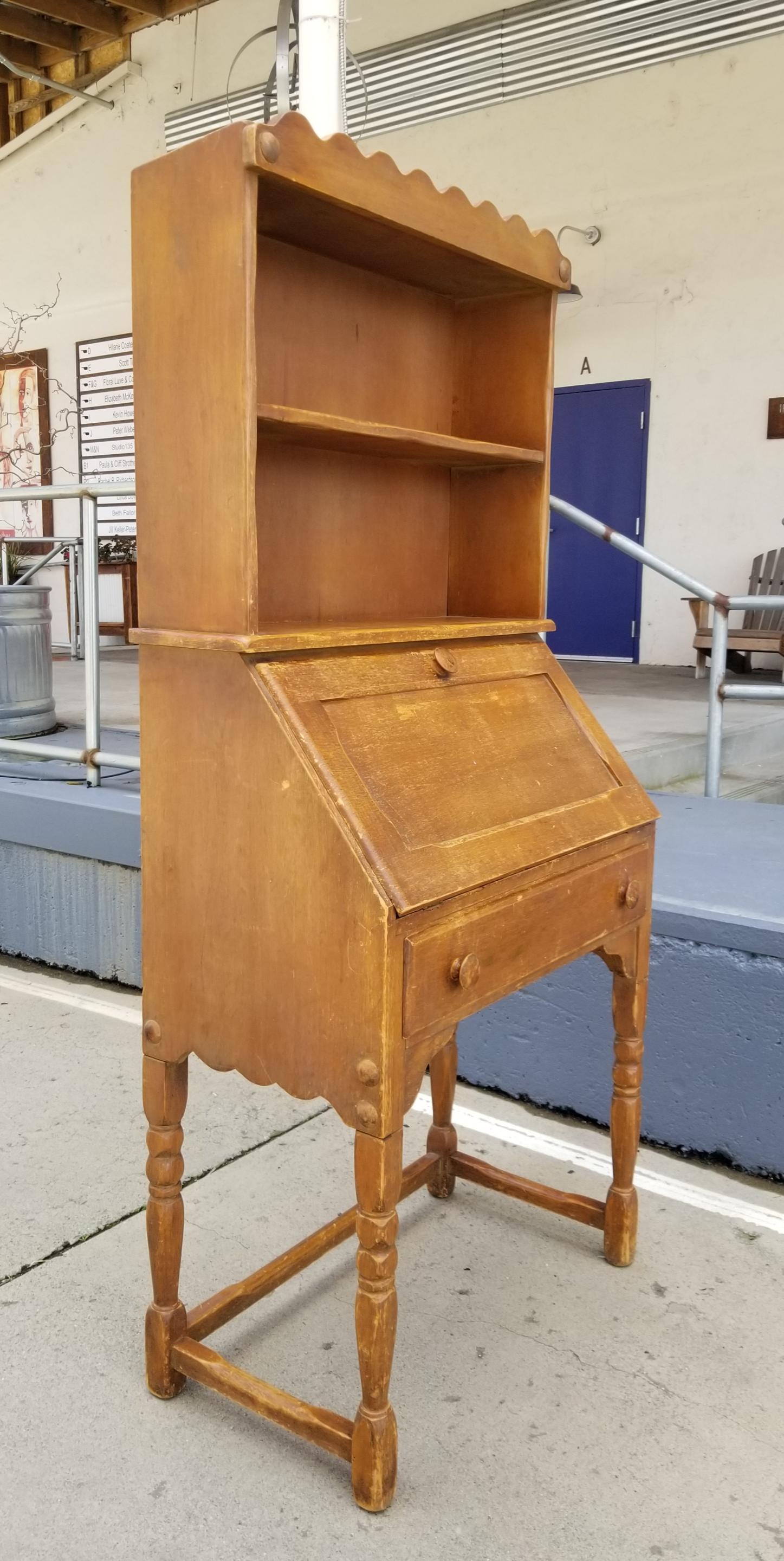 A rustic California Rancho or Spanish Colonial style drop-front secretary desk made by Monterey Furniture of California, circa 1930s. Retains original finish with branded 