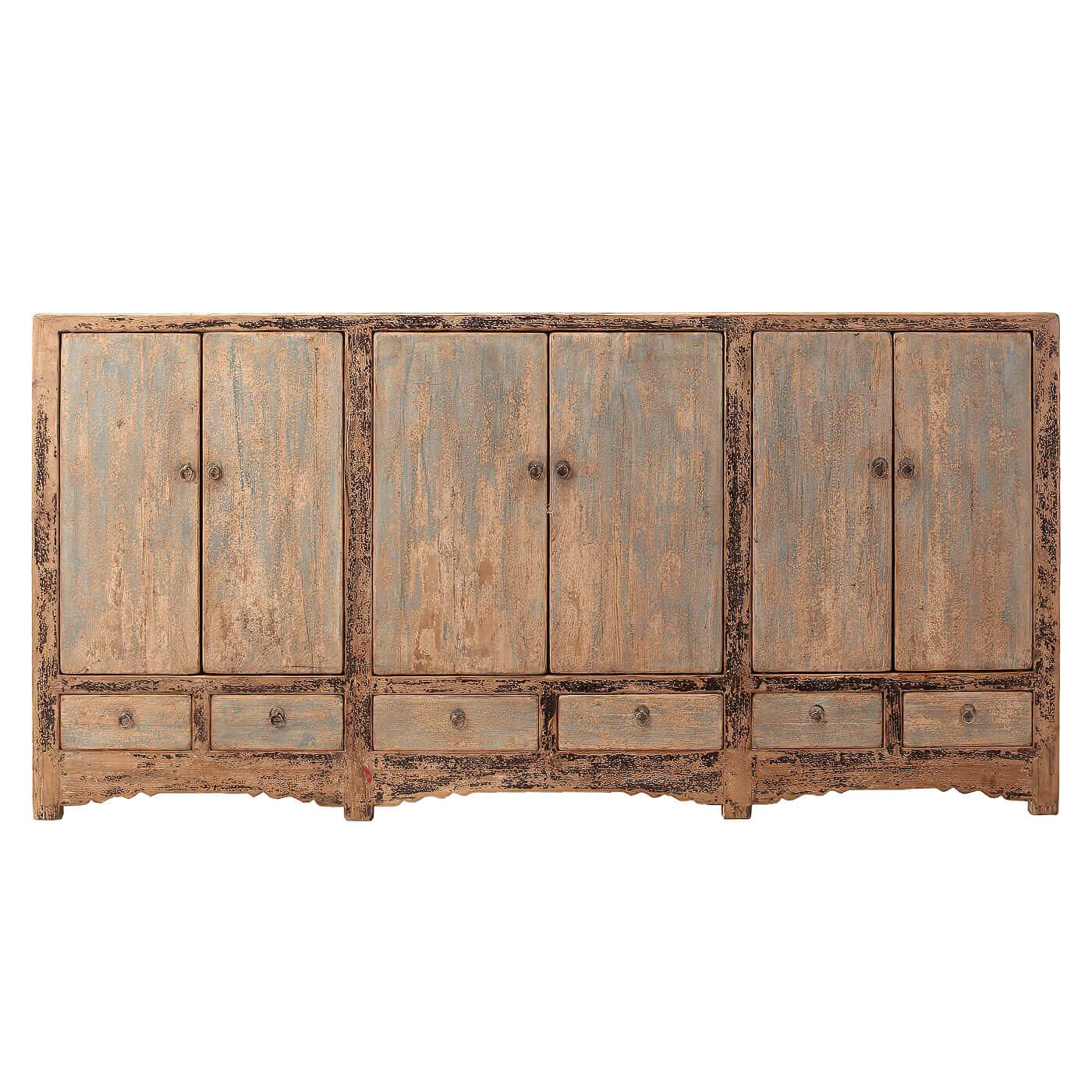 A rustic sideboard with six doors. This sideboard is a nice large size with six doors and three drawers accented with iron ring pull hardware. It is crafted in reclaimed pine and has a beautifully carved arch base. 

This piece has a unique