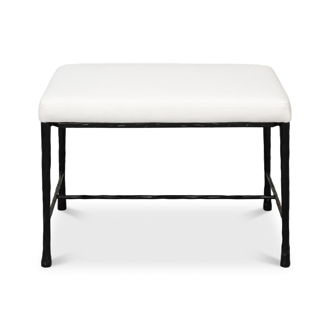 Its sturdy handwrought iron base features a textured finish and tapered legs, showcasing authentic artisanal design. Topped with an upholstered seat, this bench offers both comfort and style in equal measure.

Ideal for entryways, bedrooms, or small
