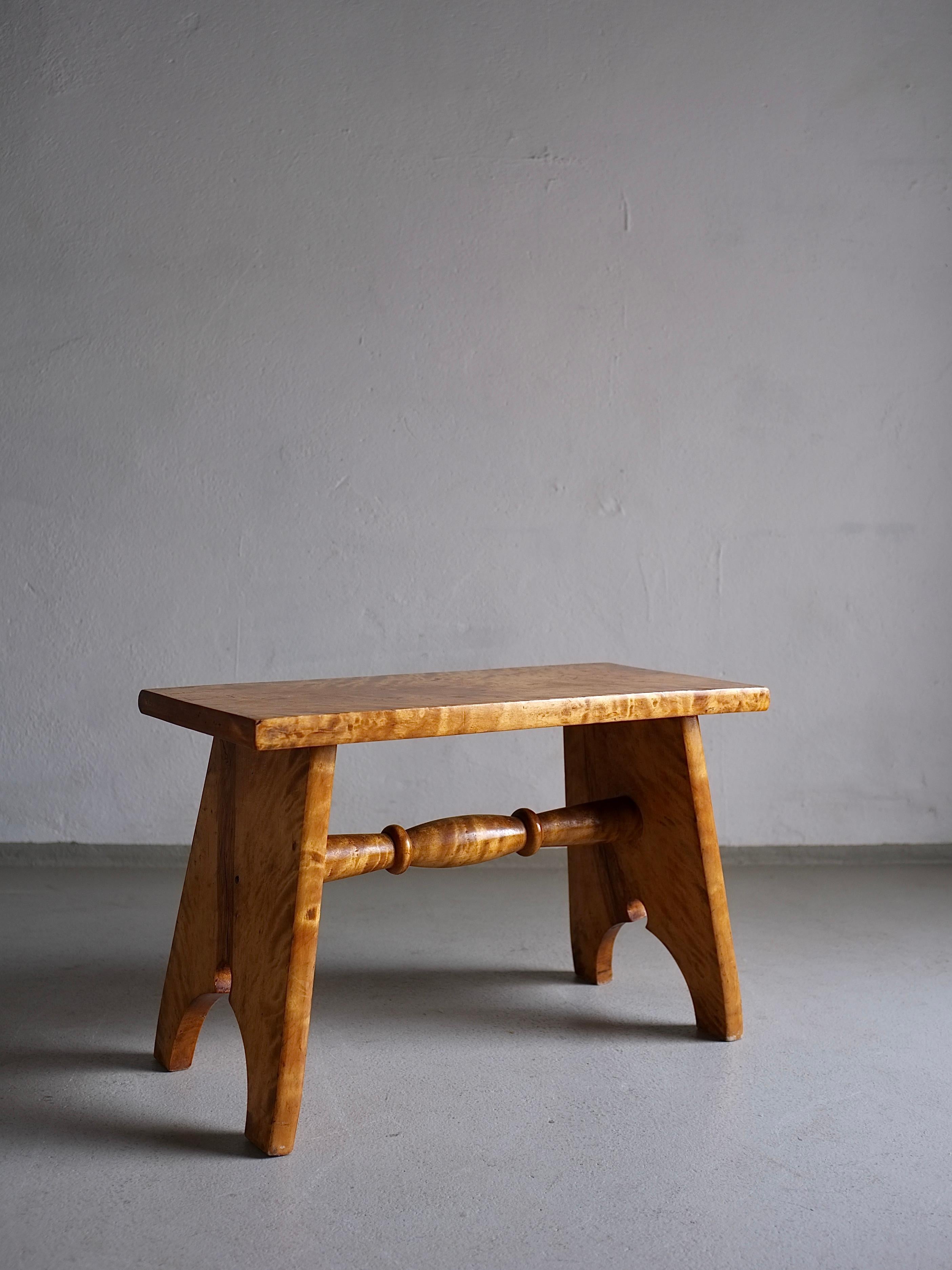 Carved low stool made of solid Karelian birch wood.