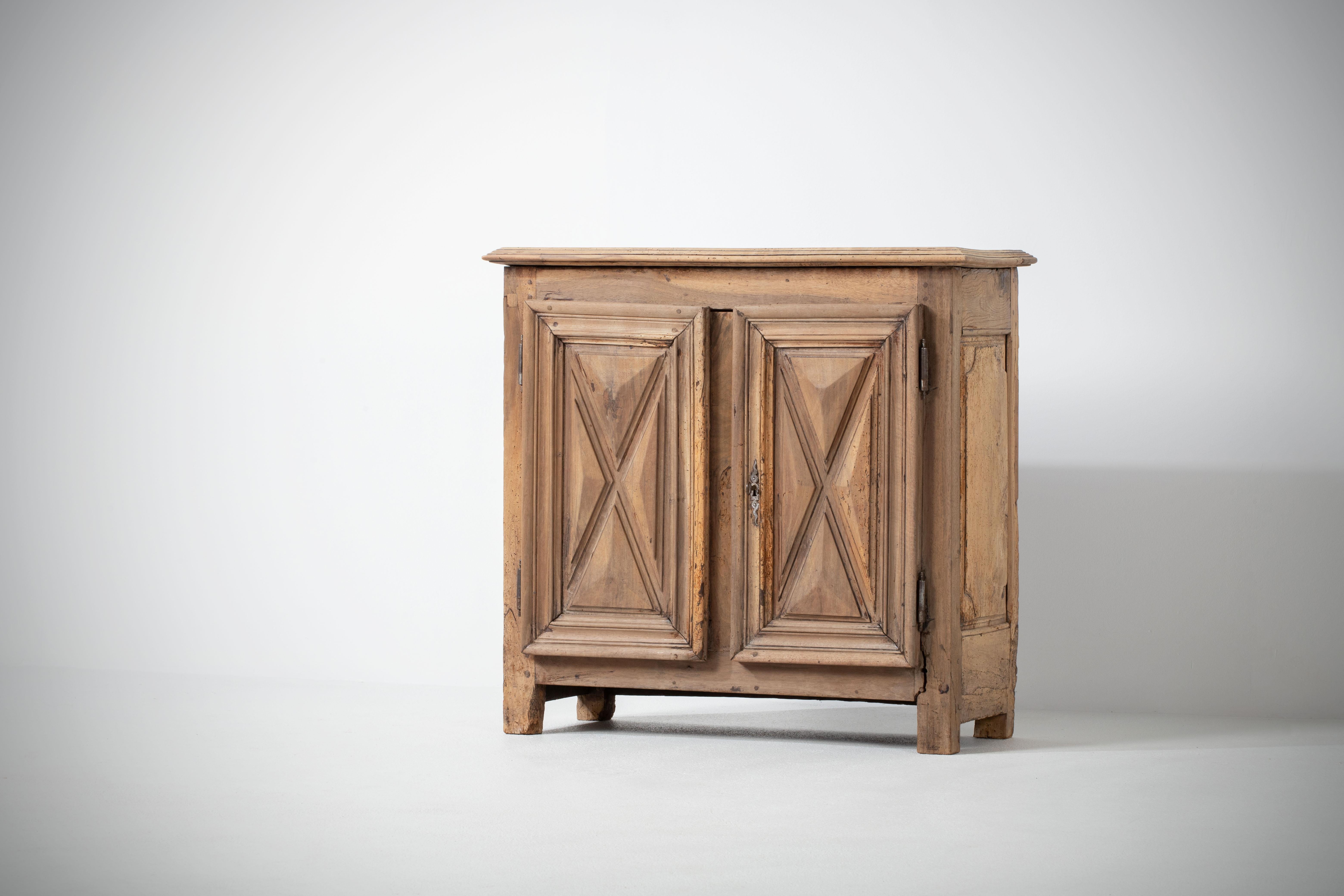 Credenza, solid oak, France, 1920s
Art Deco Brutalist sideboard. 
The credenza consists of two storage facilities and covered with very detailed designed doors.
 