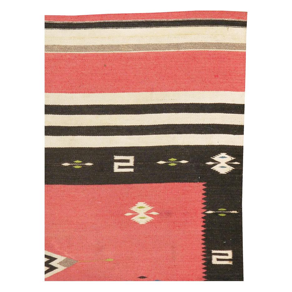 A vintage North American Navajo tribal flat-weave small accent rug in the rustic southwestern style handmade during the mid-20th century.

Measures: 4'6