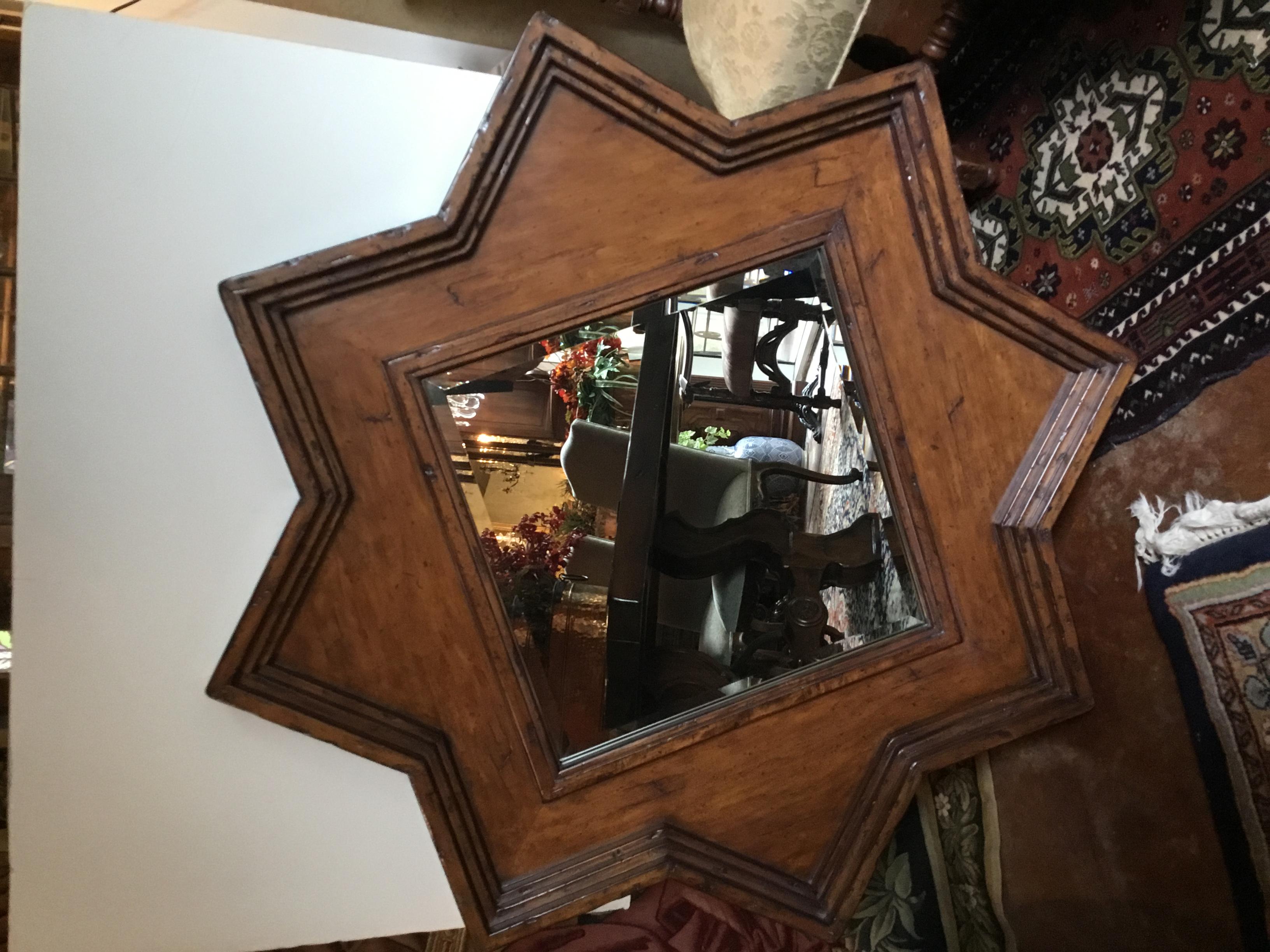 Handsome rustic look with a beveled mirror housed in a star shaped
frame. Great for farm house or cabin. The frame is made from reclaimed
timber. Eight sided star.