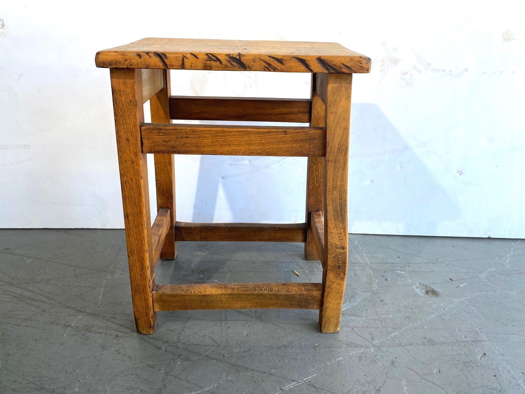 Rustic style stool with stretcher. 