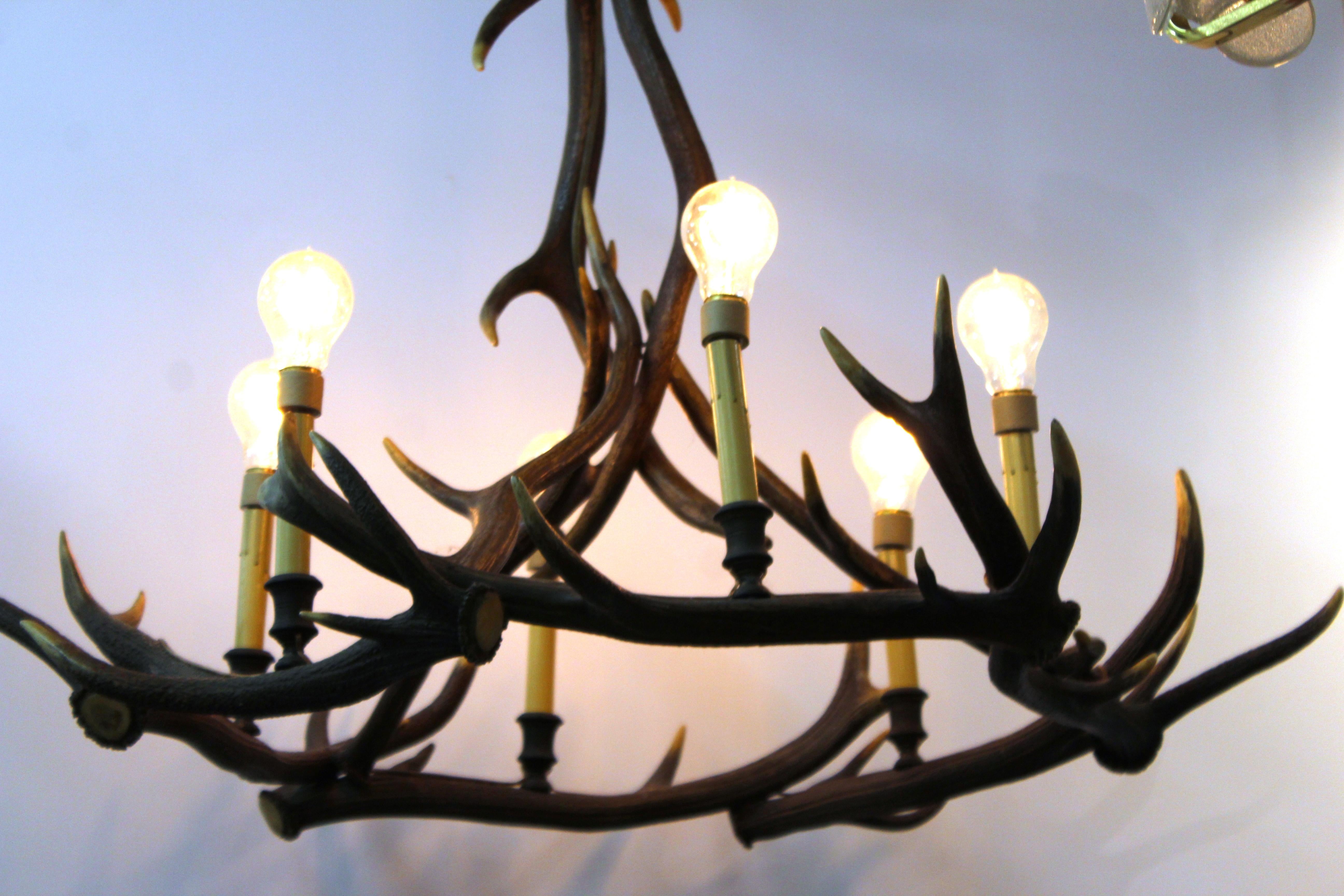 Rustic style vintage chandelier with genuine antlers and six lights. The piece was made during the early 20th century, possibly in France, and has an elegant natural patina. In great vintage condition with age-appropriate wear.