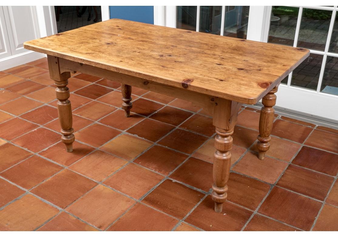 A well made Pine Farm Table with boldly turned legs. Strong and durable with a great Rustic presentation. The wood has mellowed to a deep Antique style finish. 

Condition: There are various signs of age to the top including scratches, rings, burns,