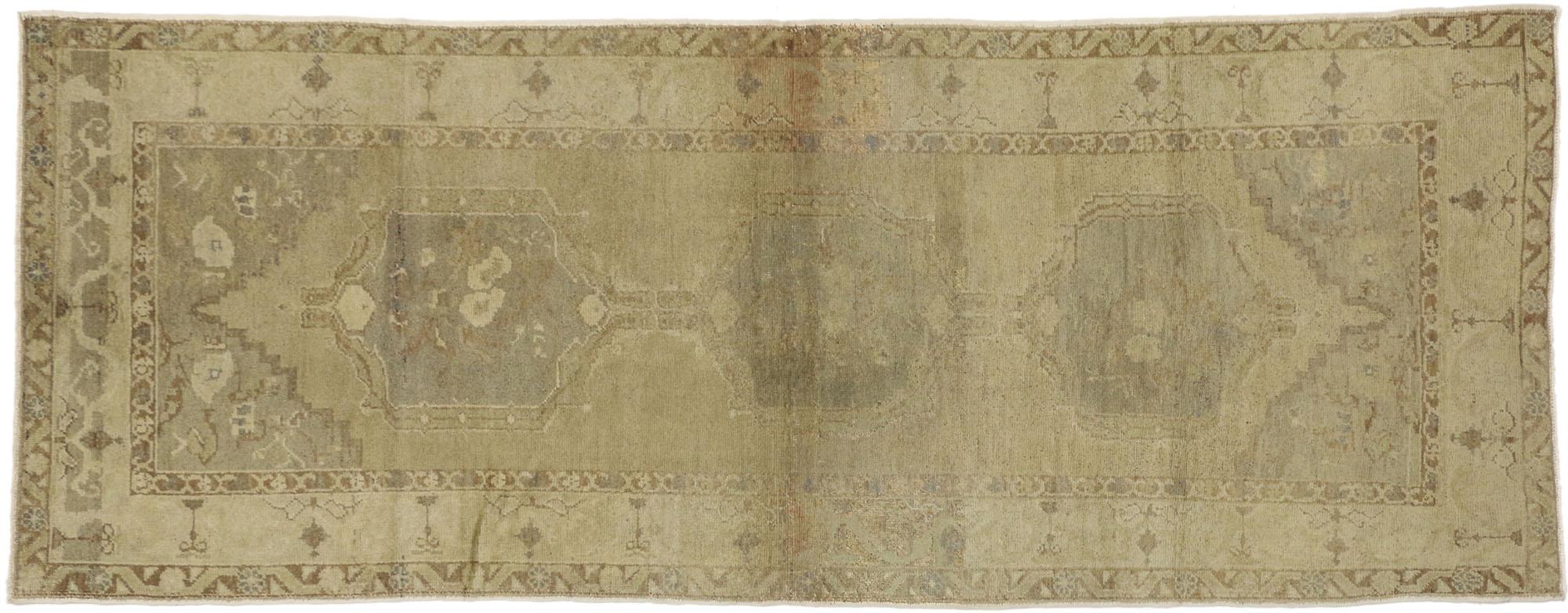 50837 Vintage Turkish Oushak Runner, Hallway Runner, 3'10 x 9'10. This hand-knotted wool vintage Turkish Oushak runner with rustic style features three amulet-style medallions on an abrashed ecru background. It is surrounded by a delicate border and