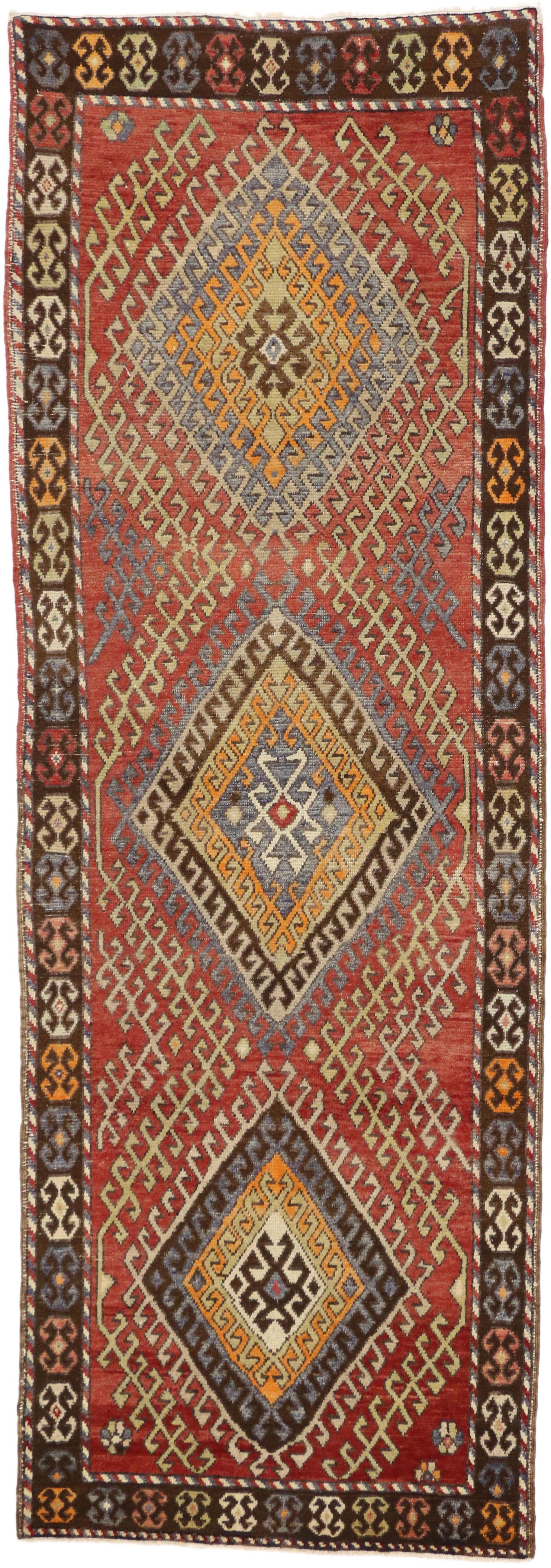 50340 Rustic Style Vintage Turkish Oushak Runner, Tribal Hallway Runner. This hand-knotted wool vintage Turkish Oushak runner features three stacked lozenge medallions with latch hook edges and steep latch hooked ziggurats protruding towards the