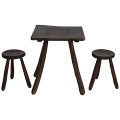 Rustic Table and Two Tripod Stools of Profiled Wood Logs
