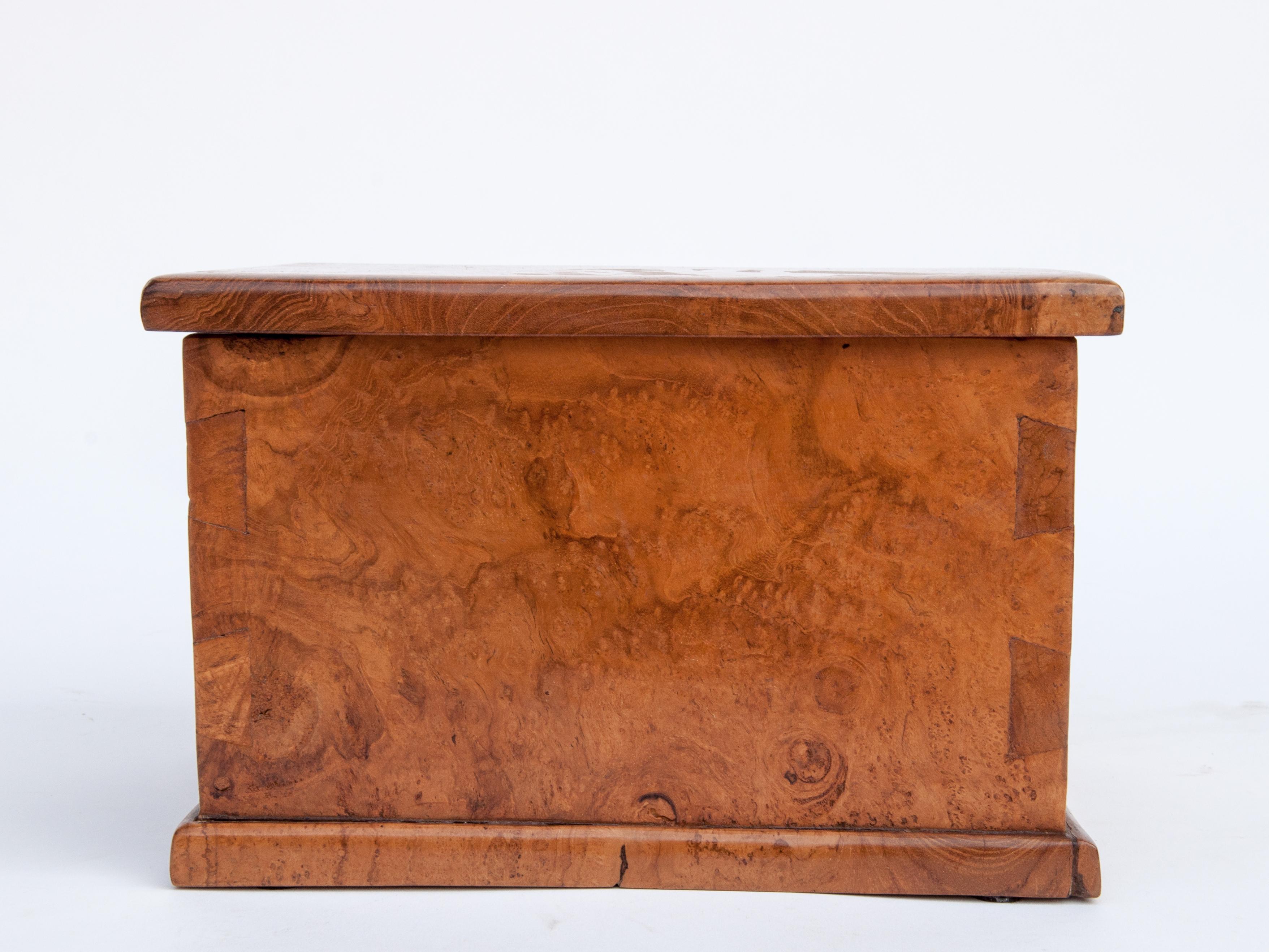 Rustic teak Burlwood box 11.75 x 8.5 x 8.5 inches tall. Java, late 20th century.
This tabletop box is entirely fashioned from solid pieces of teak burl wood. Its charm lies in its rustic simplicity, and the lovely pattern of the burl.
Condition: